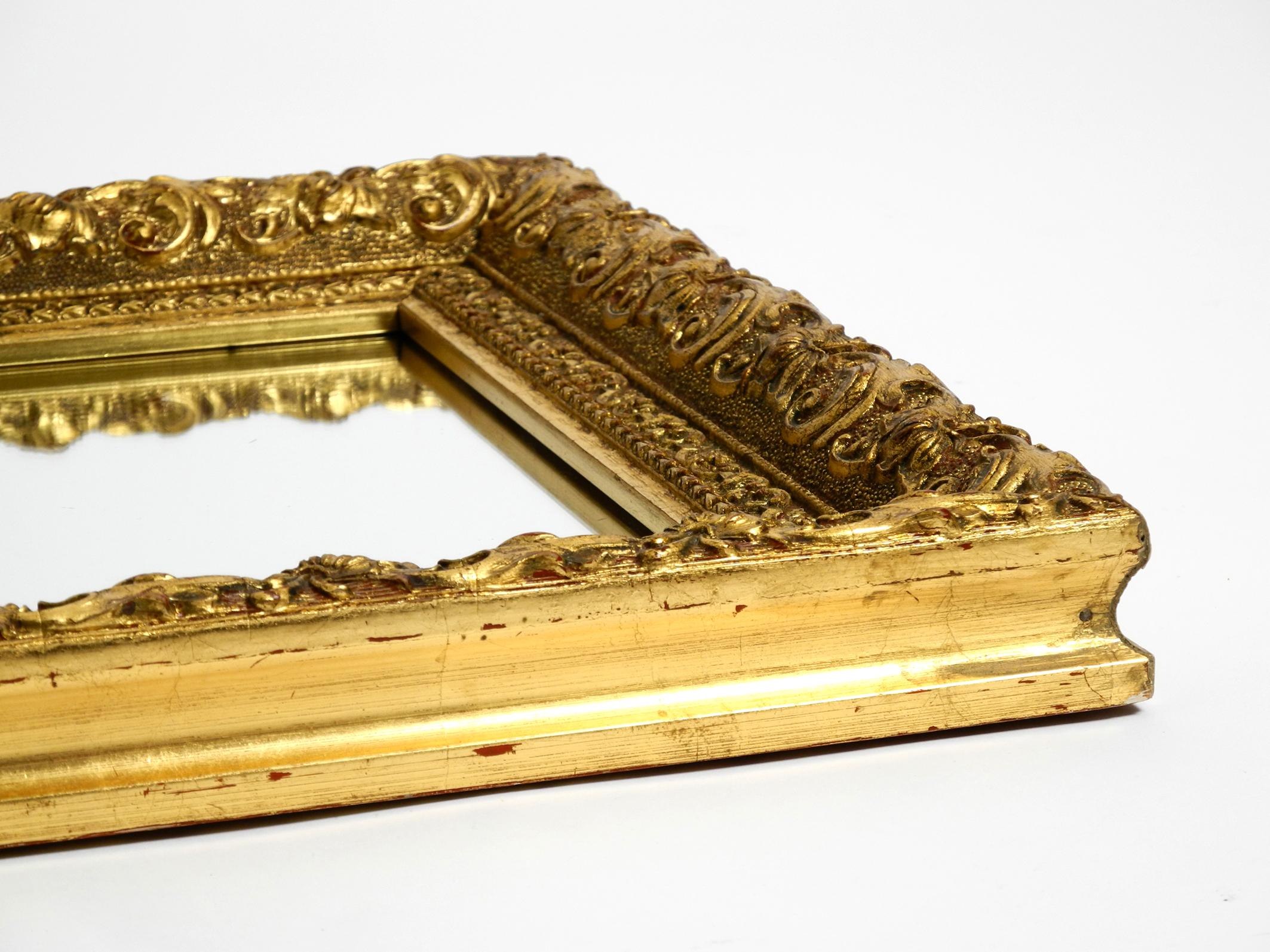 Beautiful Mid Century Wall Mirror from Italy with an Ornate, Gold-Plated Frame In Good Condition For Sale In München, DE