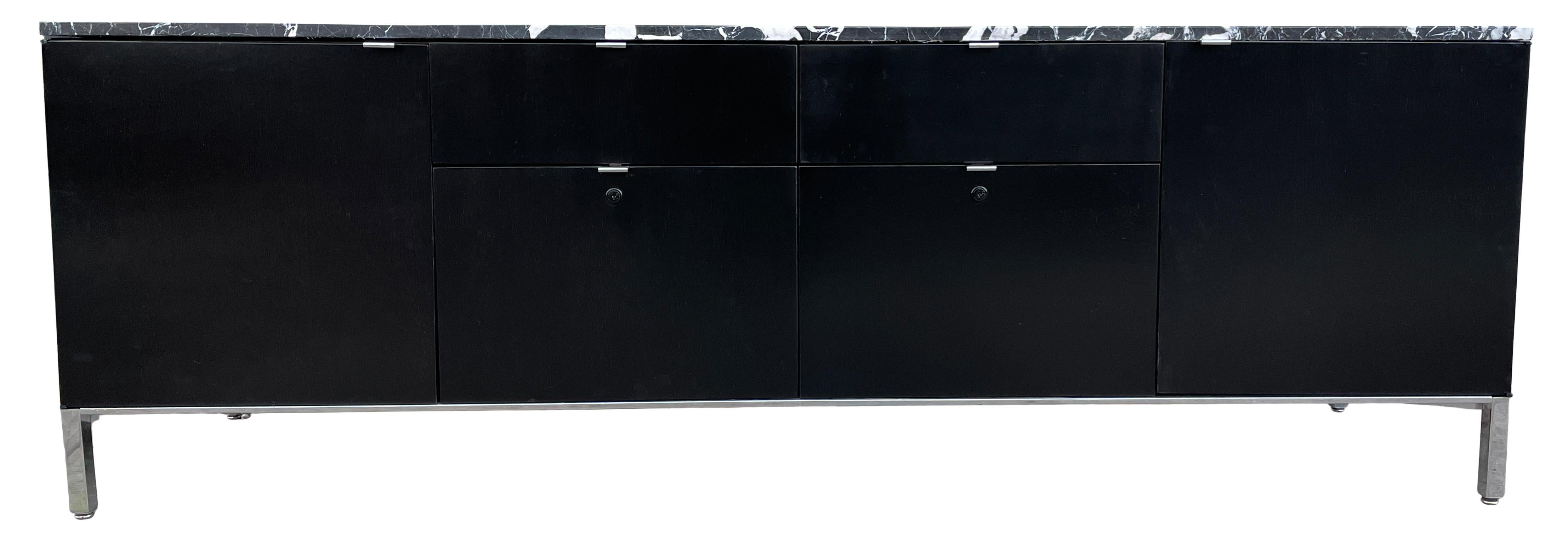Beautiful and sophisticated Stow Davis low credenza in black lacquer. Featuring two deep lower file cabinet drawers, two top shallow drawers and two cabinet doors with adjustable shelves on a chrome base with chrome pulls. Sleek and ready for use