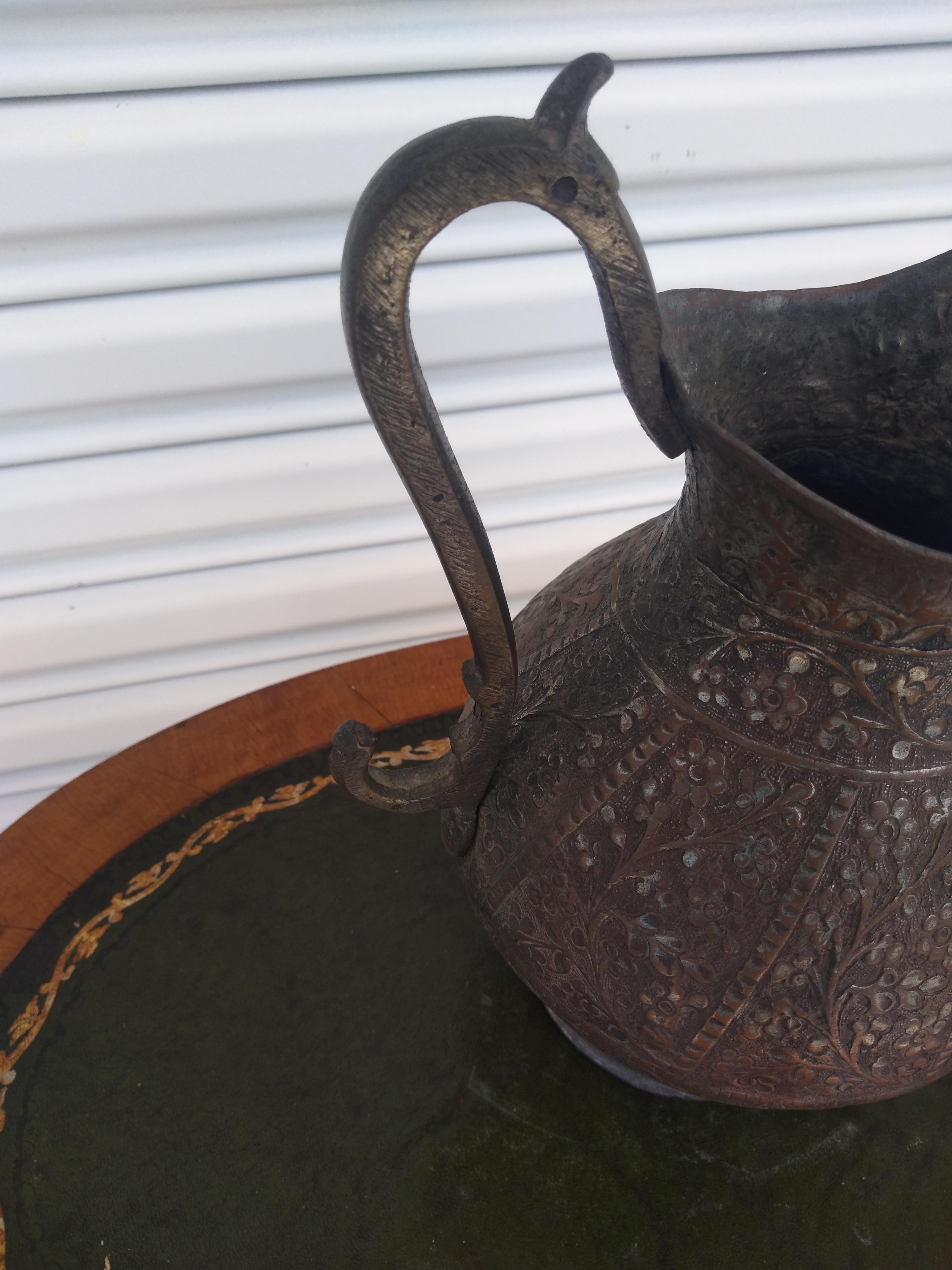 This is a beautiful hand forged pitcher. It was made in the Middle East in the Islamic style. It's completely hand forged metal. The handle being made in a heavy hand forged steel.