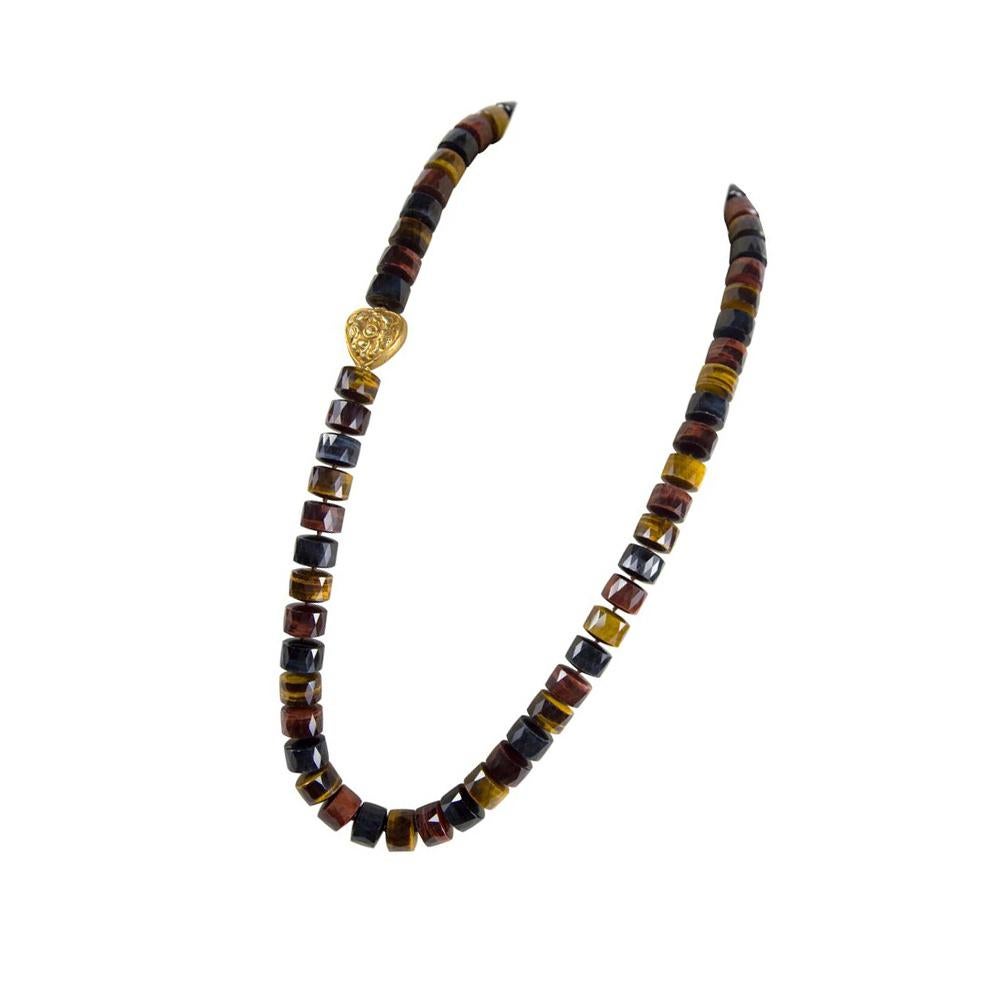 Sensational Large Tubular Facet-cut multi-color Tiger Eye and Gold bead Statement Necklace, enhanced with a gilt brass Heart shaped bead; approx. 1” long x 1” wide; 59 multi-color Tiger Eye beads; each approx. 17.5mm in diameter. Approx. length of
