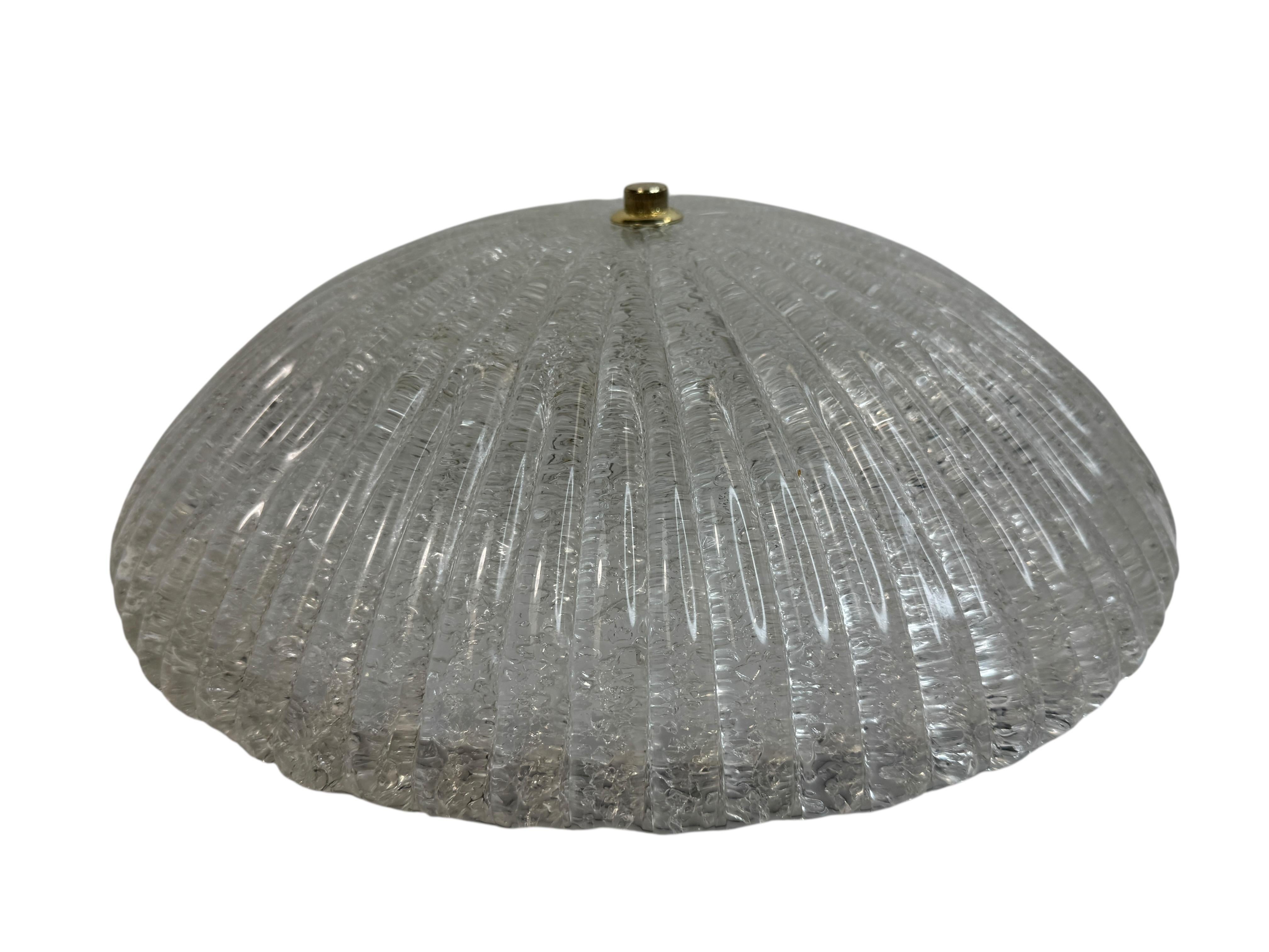 A beautiful Murano glass flush mount.  Glass made in Italy in Murano brought to Germany and sold by Massive Lighting Group in the 1980s. Gorgeous textured glass flush mount with metal fixture. The Fixture requires two European E27 / 110 Volt Edison
