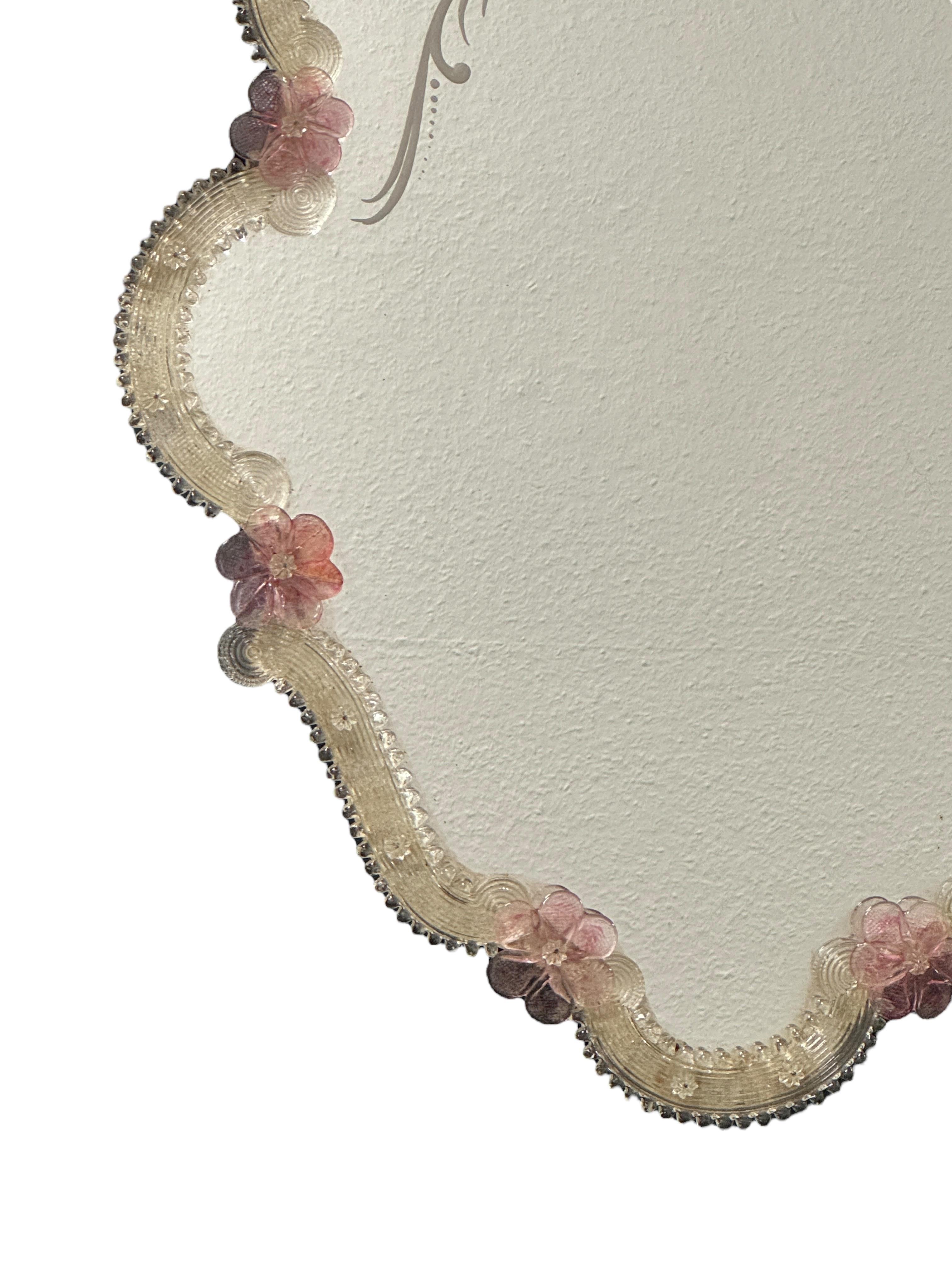 A stunning Murano glass mirror surrounded with handmade light pink flaked glass flowers. It is approx. from the 1960s or older. With signs of wear as expected with age and use. Obviously this item is not new, so please check all photos before