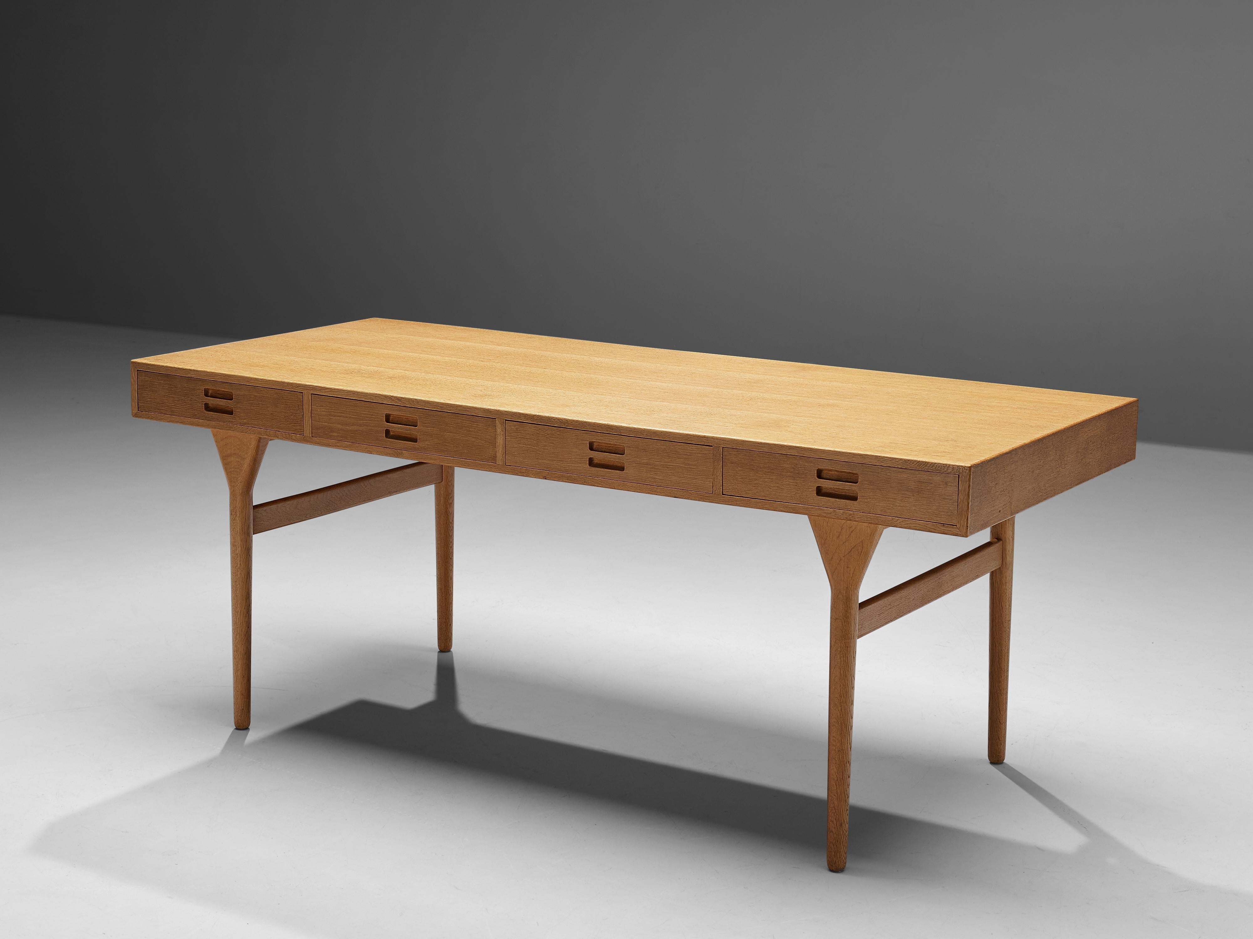 Nanna Ditzel, desk, oak, Denmark, 1950s

Danish designer Nanna Ditzel created this beautiful desk in the 1950s. Four tapered legs lift the table top with integrated drawers up. Decorative and functional detail at the same time are the handles. Two
