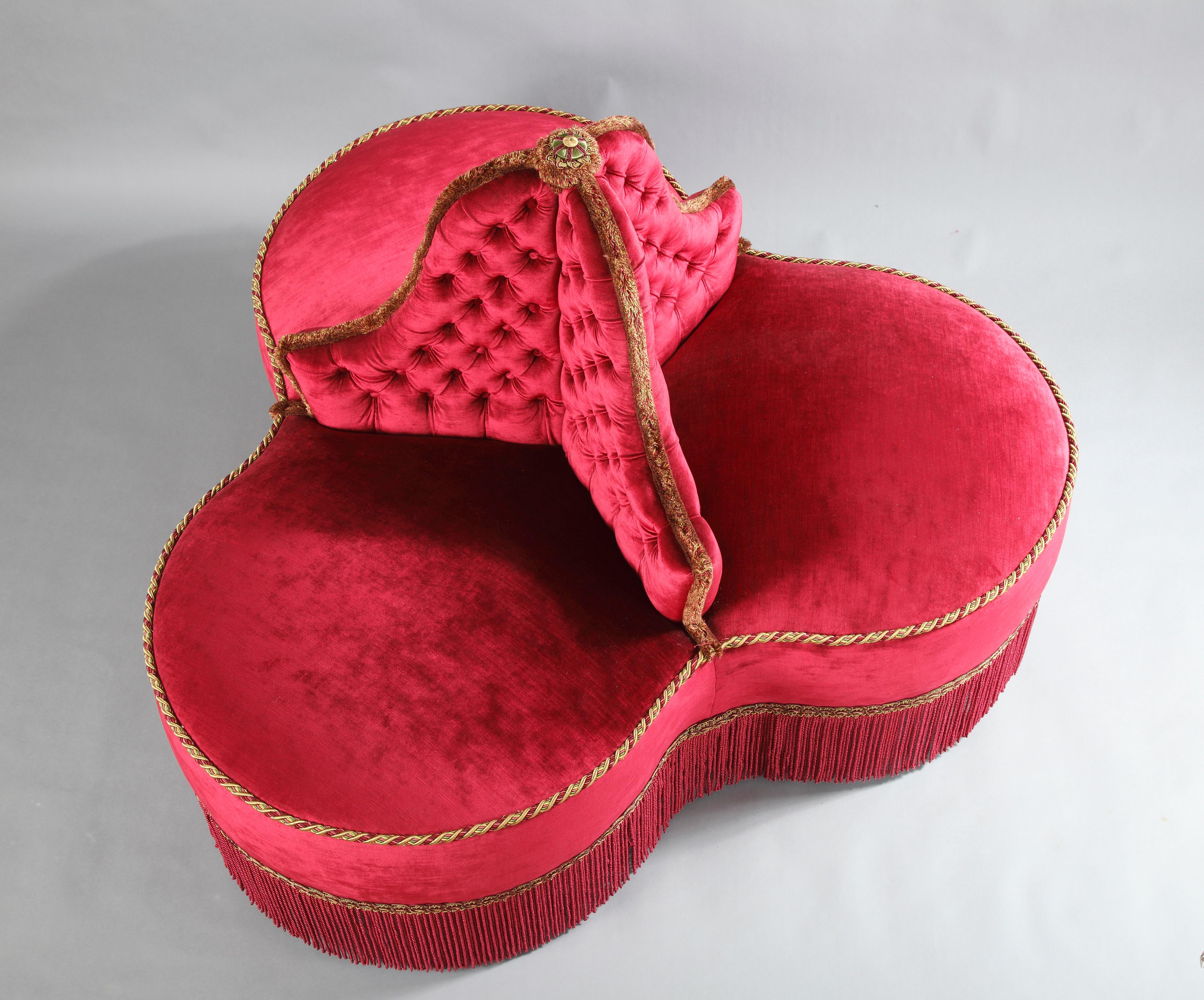 Beautiful circular couch, completely covered with a “red opera” silk velvet. It consists of three benches attached to a central shaft. Based on gilt wood fluted legs.