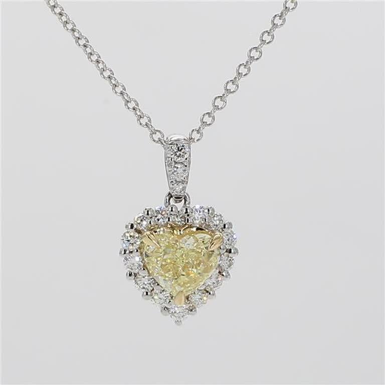 RareGemWorld's classic diamond necklace. Mounted in a beautiful 18K Yellow and White Gold setting with a natural heart cut yellow diamond. The yellow diamond is surrounded by small round natural white diamond melee. This necklace is guaranteed to