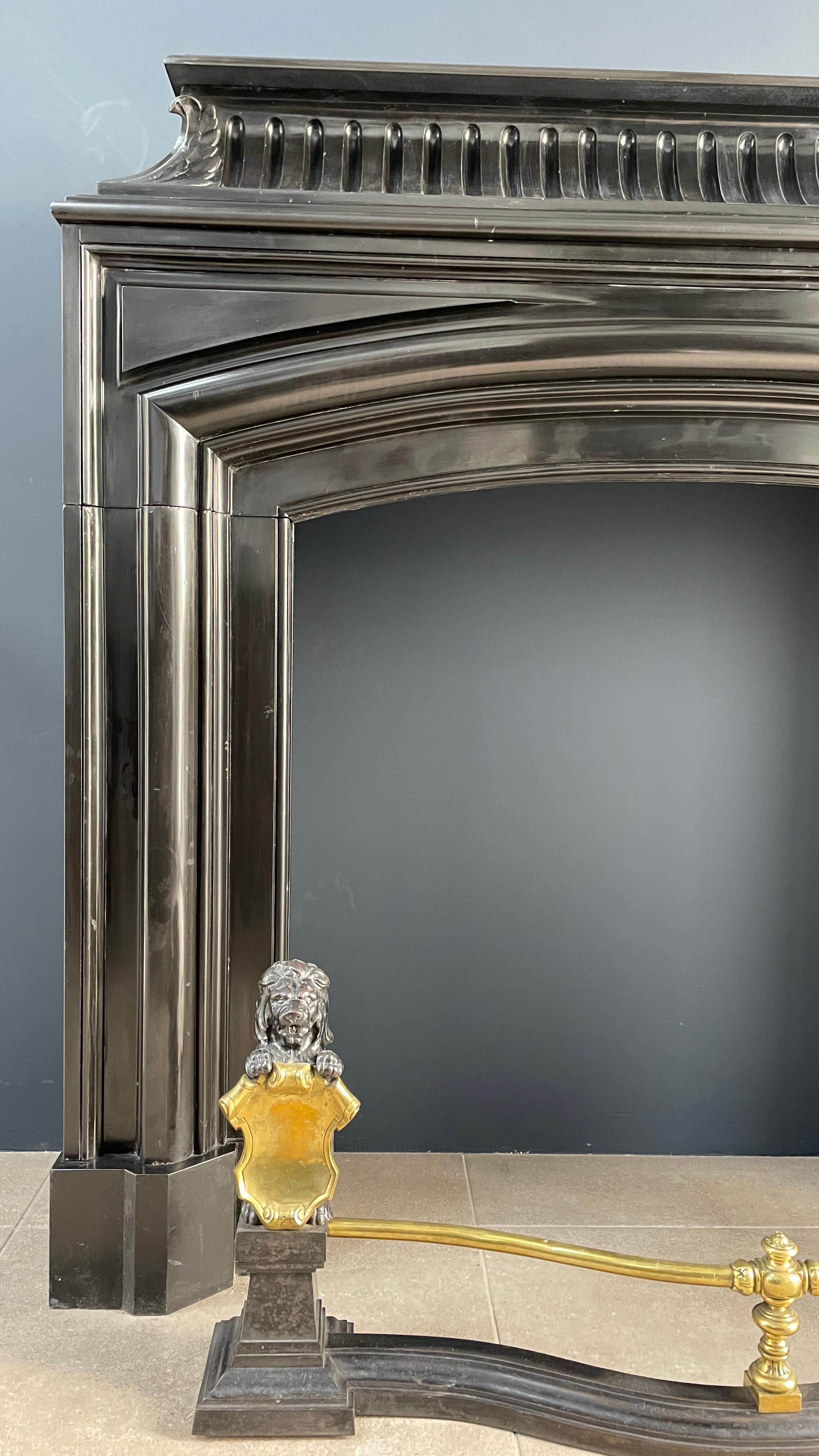 Elegance personified, the Neoclassical Noir De Mazy black marble antique front fireplace is a true masterpiece that commands attention. Crafted with meticulous precision, this stately and specially designed fireplace embodies luxury in every detail.