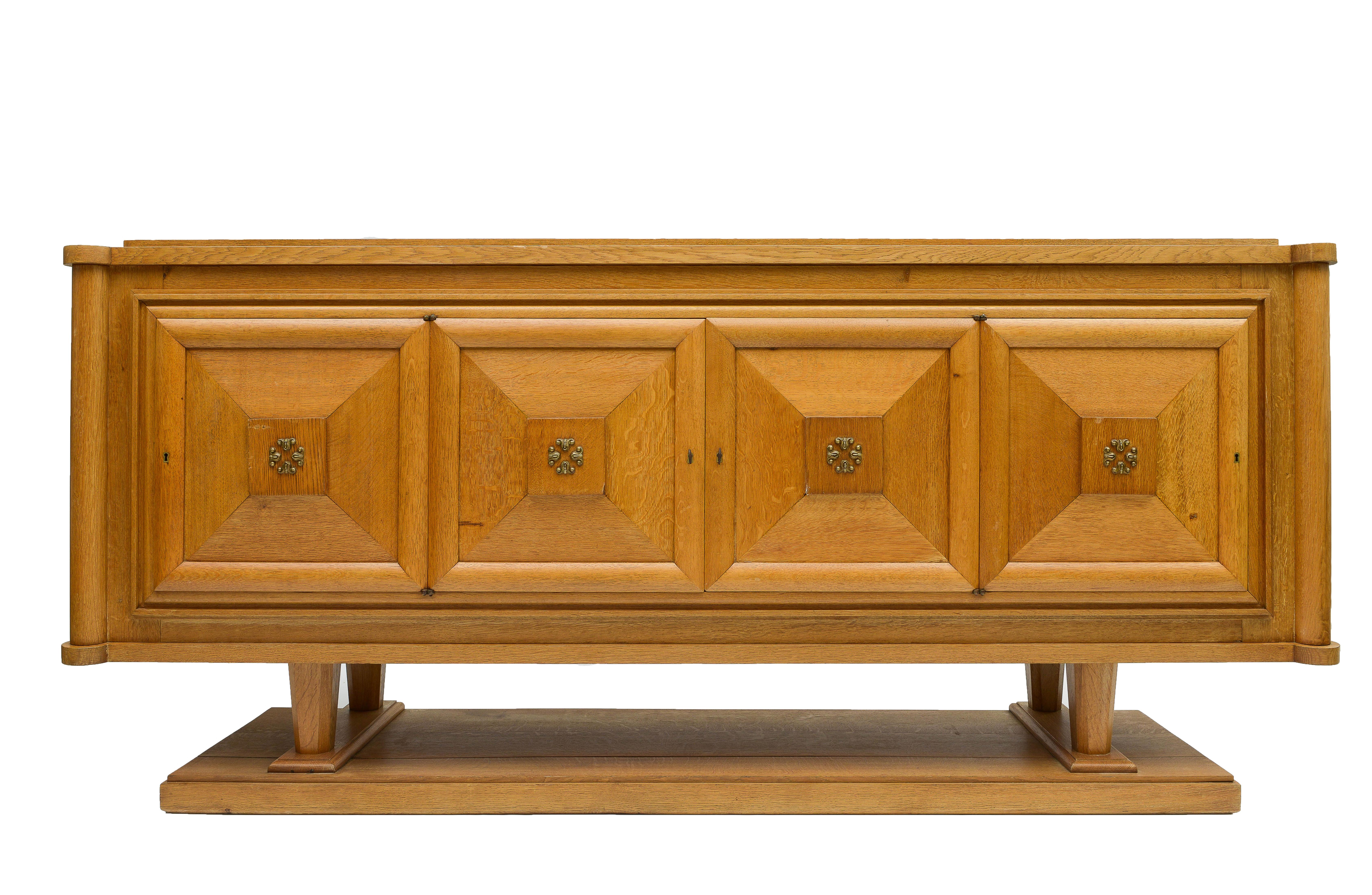 Beautiful French Art Deco sideboard. Incredible condition and lovely grain on the wood. Solid oak with lovely detailing throughout. Brass detailing on the doors.