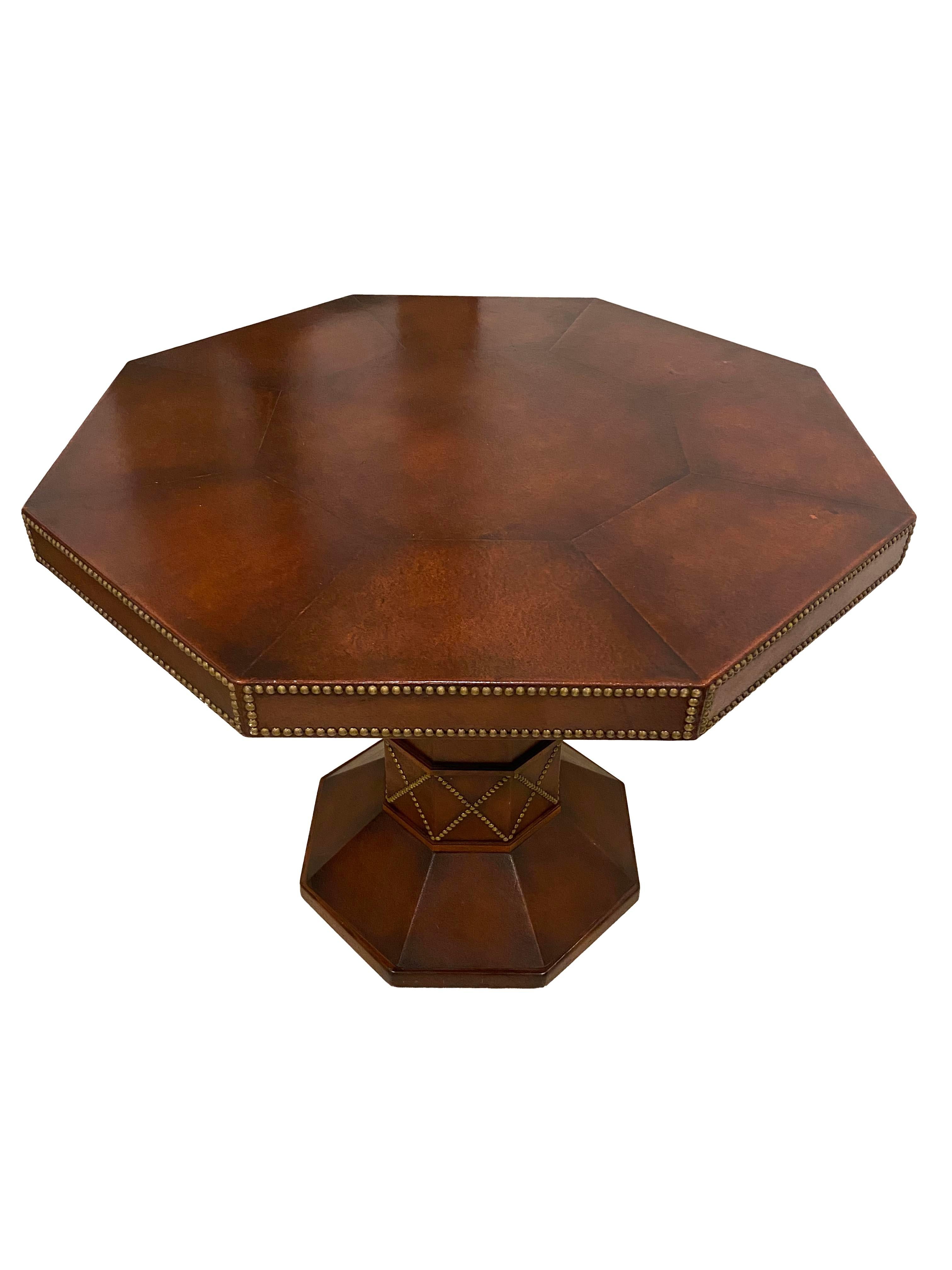 Add a touch of timeless sophistication to your space with this exquisite octagonal game table, expertly crafted in Argentina. Wrapped in rich leather, the table’s unique eight-sided top is bordered with elegant brass nailhead detailing that adds a