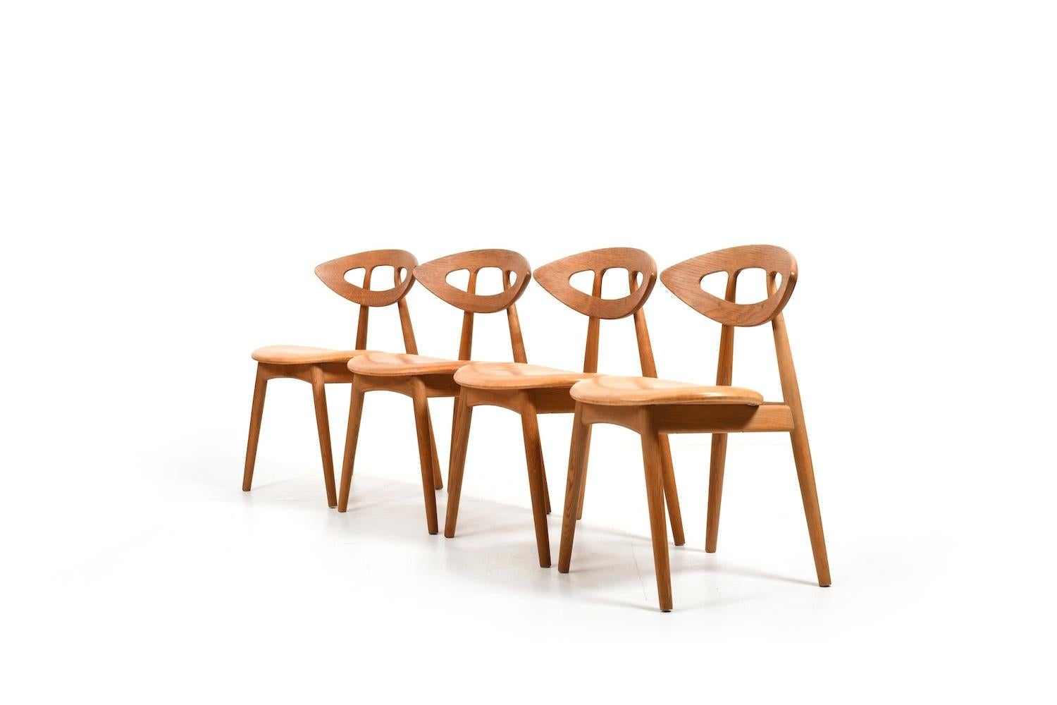 Beautiful set of four oak and patinated leather „Eye“ chairs by Ejvind A. Johansson for Ivan Gern Møbelfabrik Denmark 1960s. Design 1961. Model 84. All in original condition.