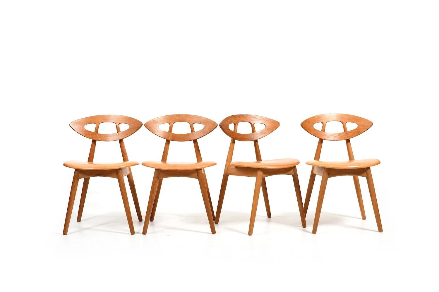 Beautiful set of four oak and patinated leather „Eye“ chairs by Ejvind A. Johansson for Ivan Gern Møbelfabrik Denmark 1960s. Design 1961. Model 84. All in original condition.