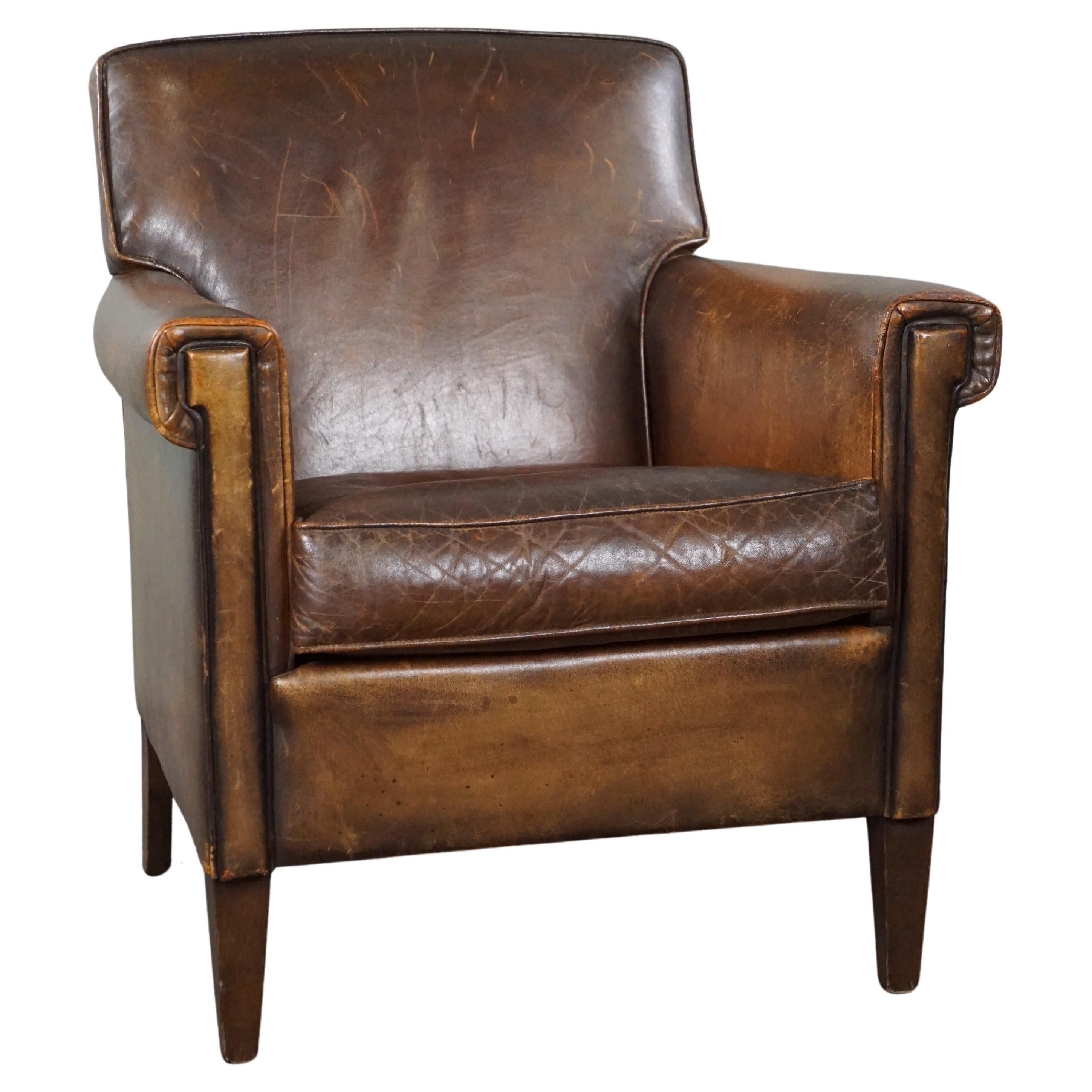 Beautiful old sheep leather armchair with a positively lived-in character For Sale