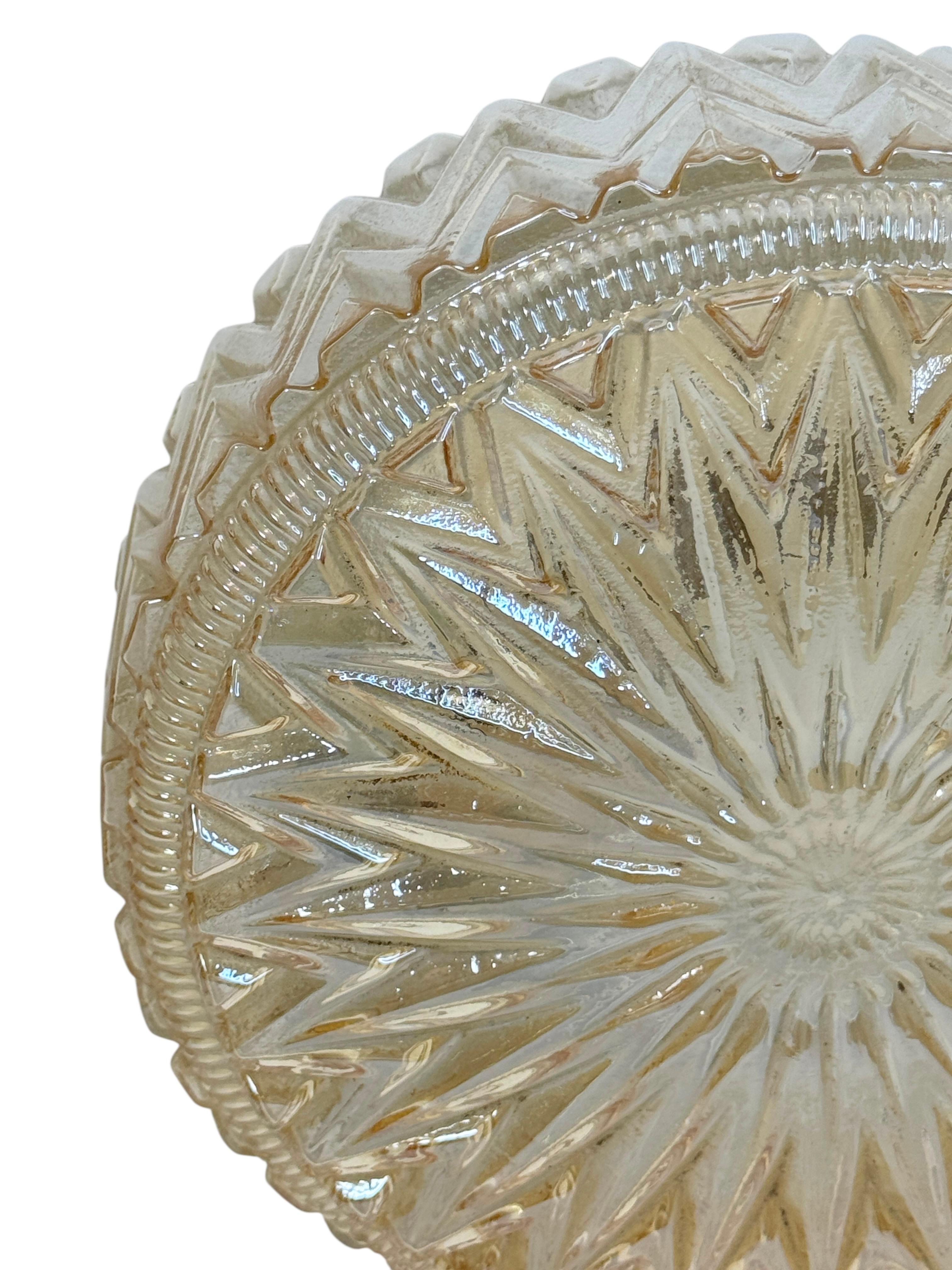 Starburst pattern amber glass flush mount. Made in Austria by a unknown manufacturer. Gorgeous textured glass flush mount with metal fixture. The Fixture requires an European E27 / 110 Volt Edison bulb, up to 60 watts. Found at an estate sale in