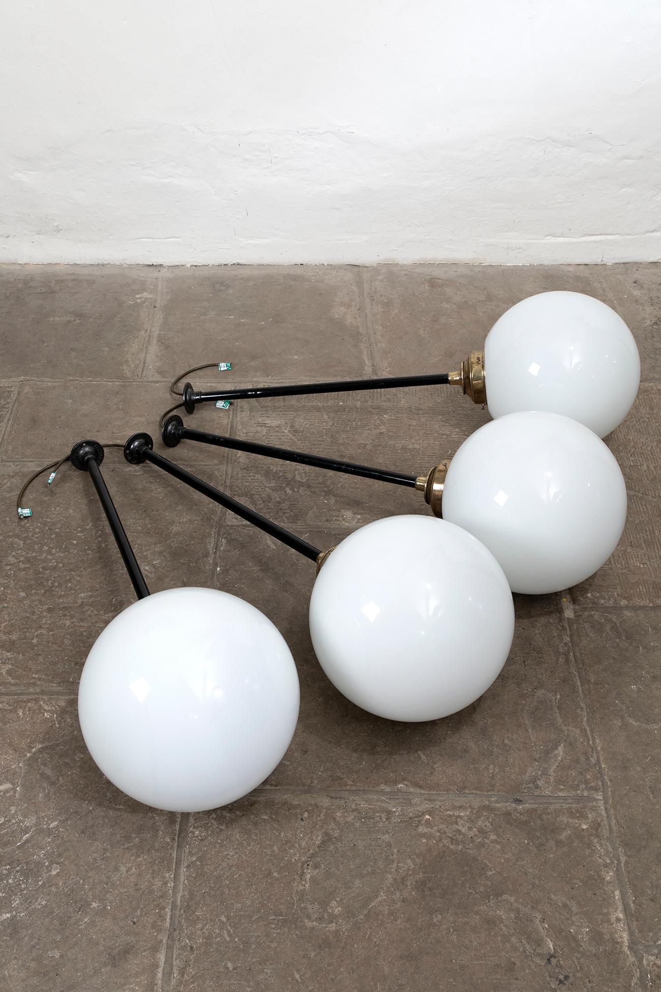 Beautiful opaline ball ceiling lights with heavy rods, brass fixings, and faux brass galleries. Originally hung above the bar at The Plough Inn, Winchmore Hill,  Buckinghamshire, United Kingdom. In good condition, with some age to the galleries. The