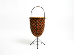 Beautiful original Mid Century rattan laundry basket with metal tripod frame