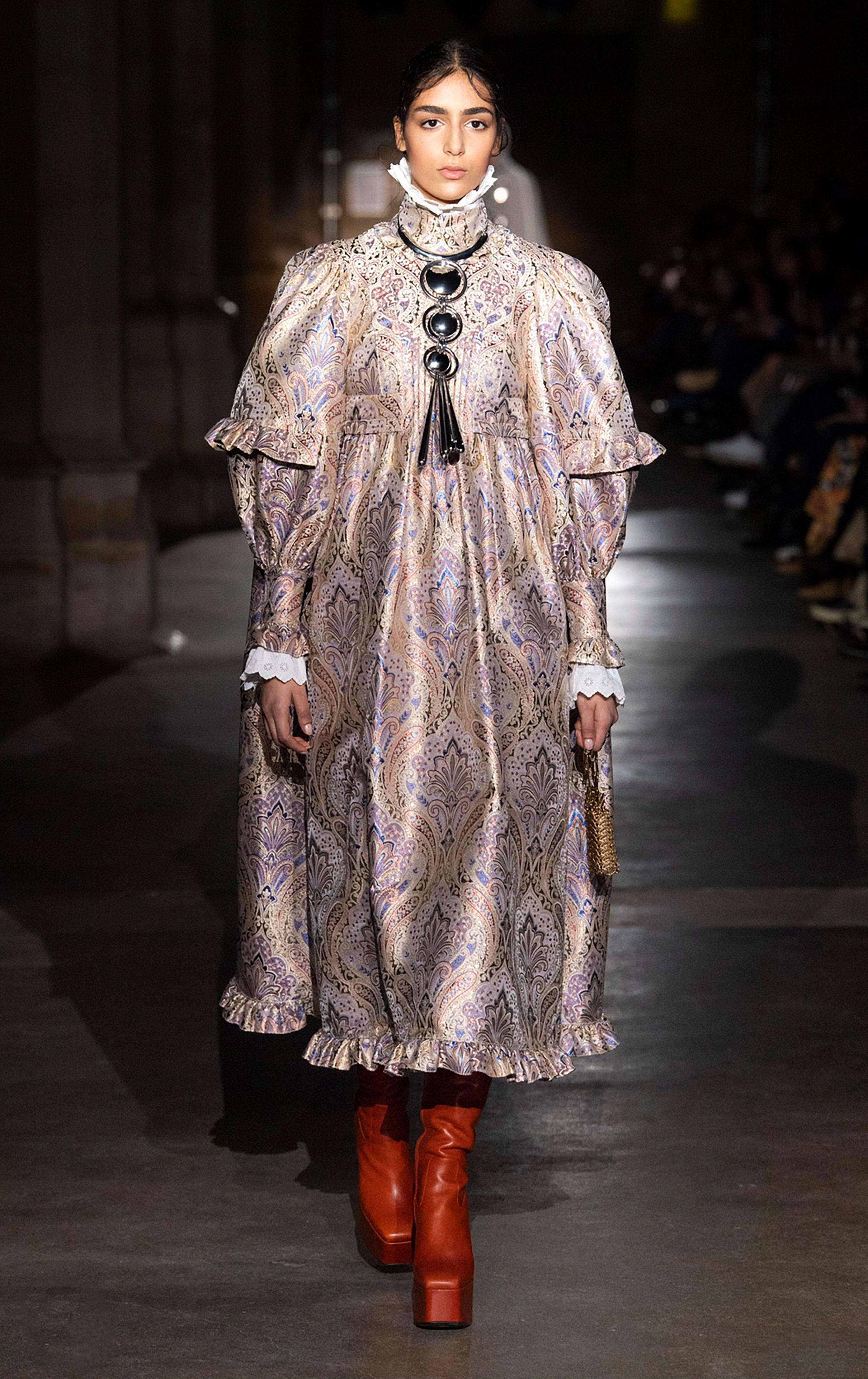 In a hypnotic interplay of opulence and irony, Paco Rabanne’s Fall/Winter 2020 Collection delivers a baroque fever dream - none more emblematic than this look: a beautiful brocade gown that seems to have emerged from the shadowy corridors of a 1970s