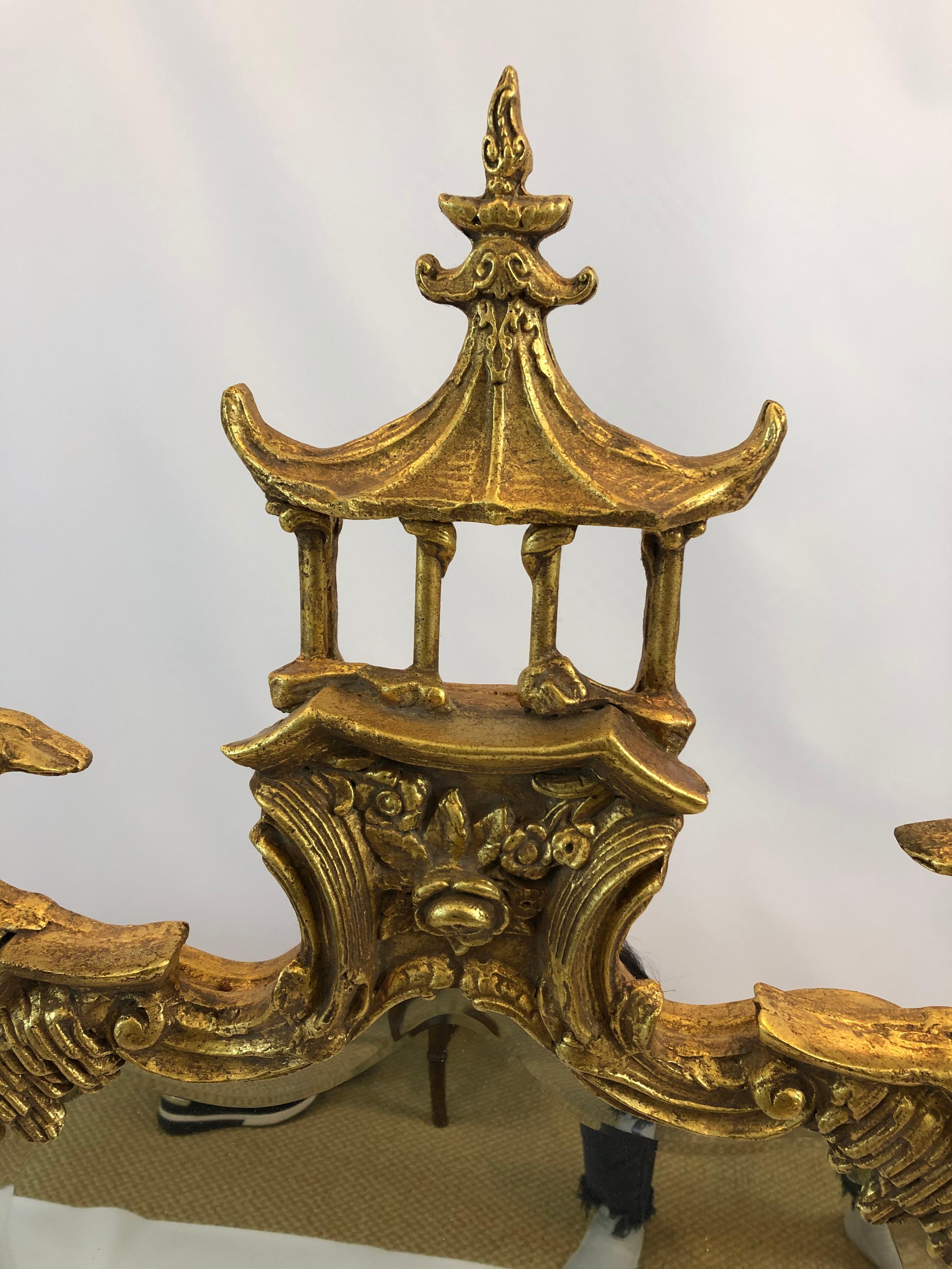 Stylish vertical mirror having marvelous pagoda at the top and winged dragons on each side with ornately carved gilded frame.