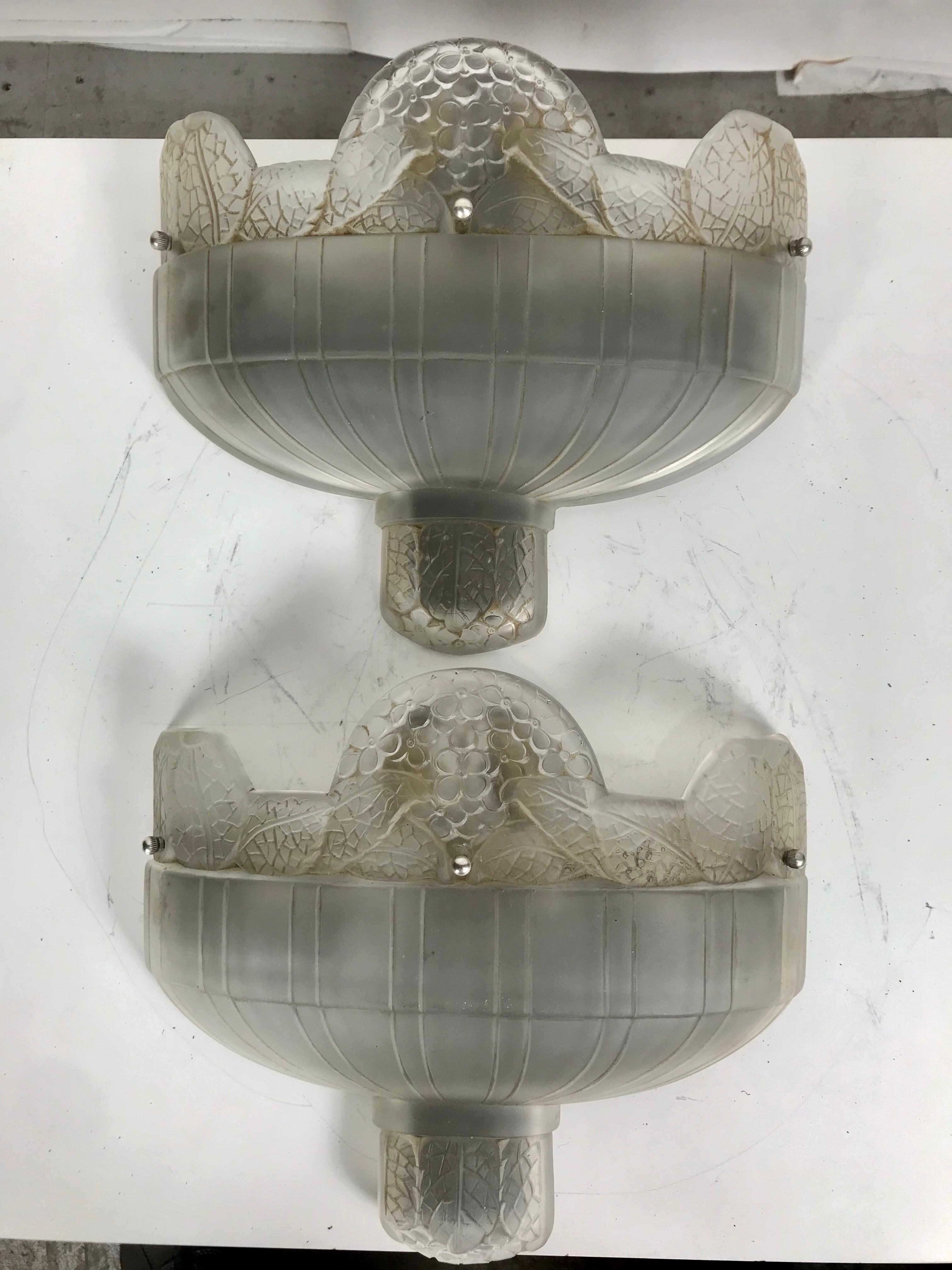 Classic pair of French Art Deco wall sconces in the style of Lalique. Frosted molded glass with floral motif. Deco details with floral design....Nickel frame impressed made in France. Retains original electrical interior fixtures. Tested and