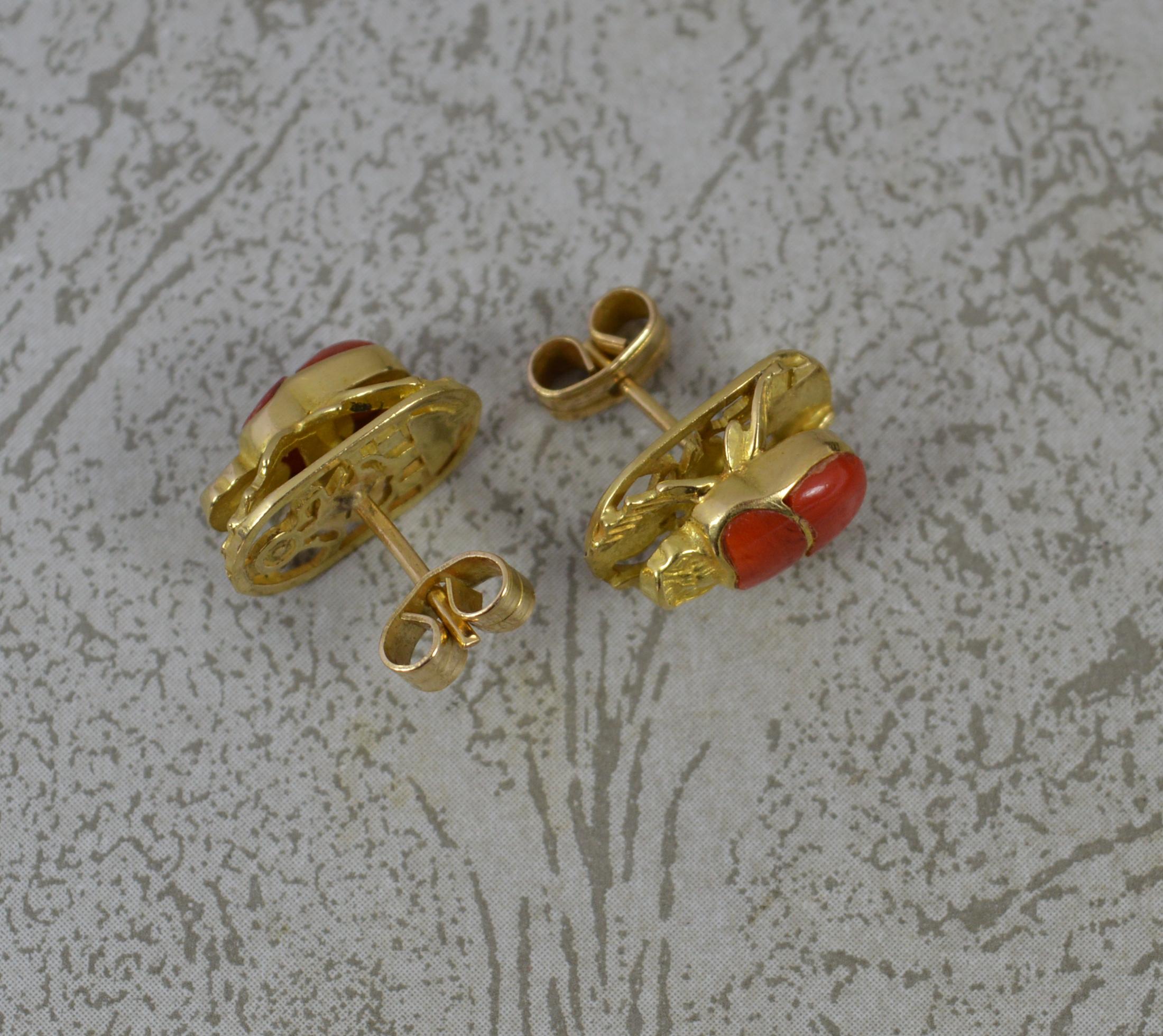 A superb pair of 18ct gold earrings.
Designed as a scarab beetle, realistically made.
Set with two pieces of coral to each.
8.5mm x 13.5mm studs.

CONDITION ; Very good. Crisp design. Issue free. Well fitted backs. Please view photographs.
WEIGHT ;