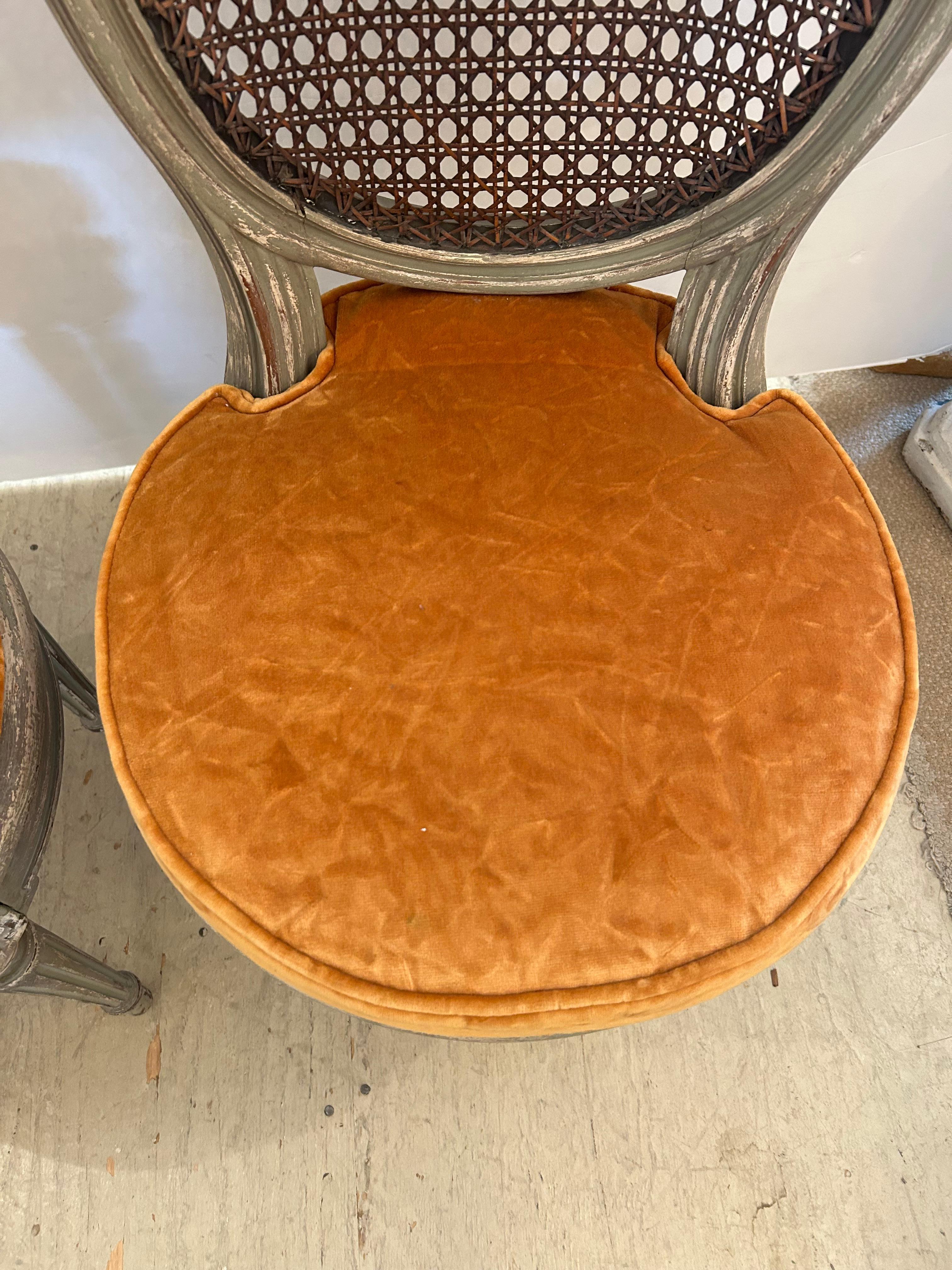 Absolutely beautiful 19th century celadon painted and caned side chairs with down orange velvet seat cushions.
seat height 18.25