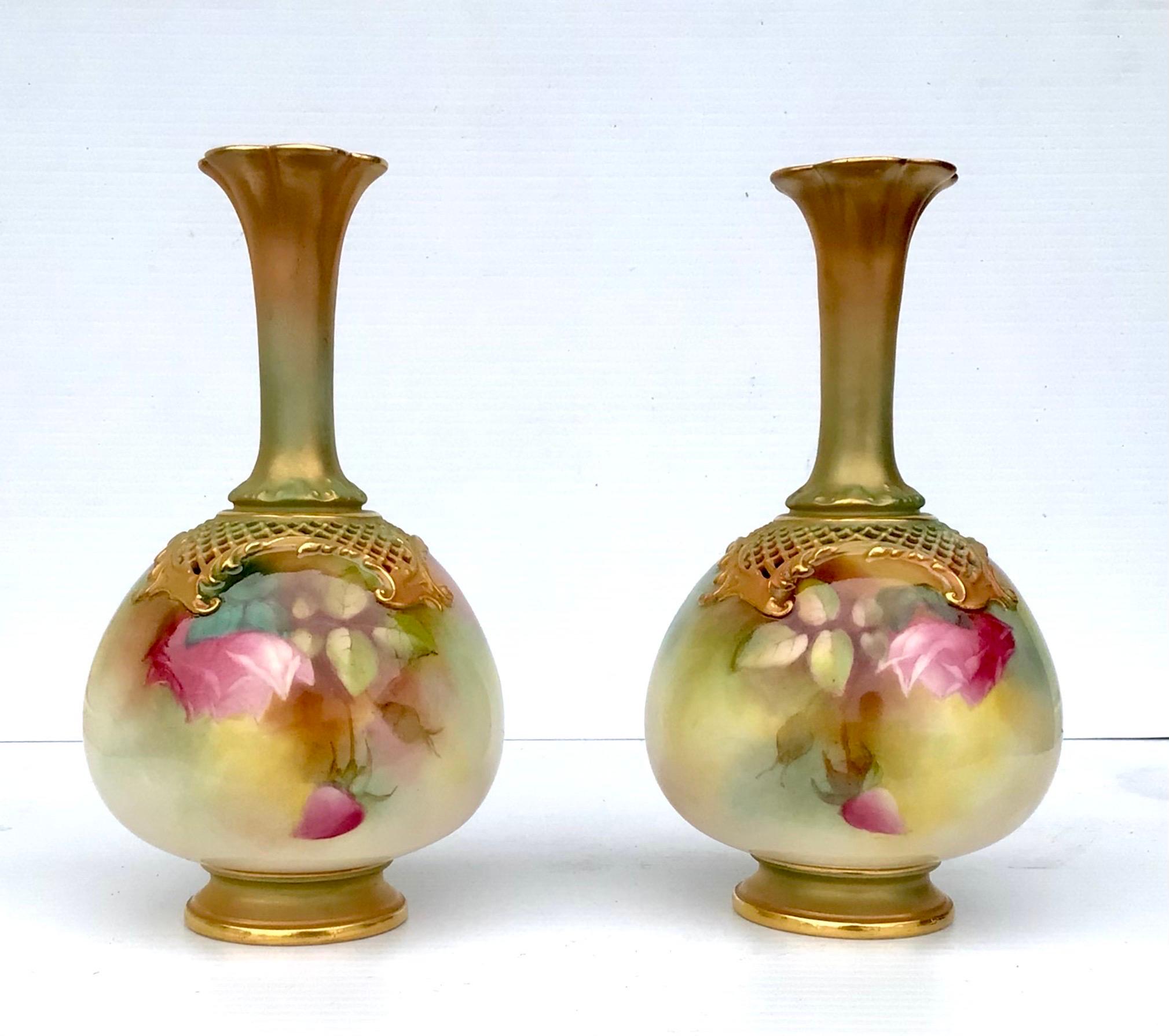 Beautiful pair of antique Royal Worcester rose painted vases, 
Dated 1911, 
Relief moulded foliate scroll and pierced reticulated trellis shoulders, 
Measures: 18.5cm high 
10cm diameter.
Superb condition.