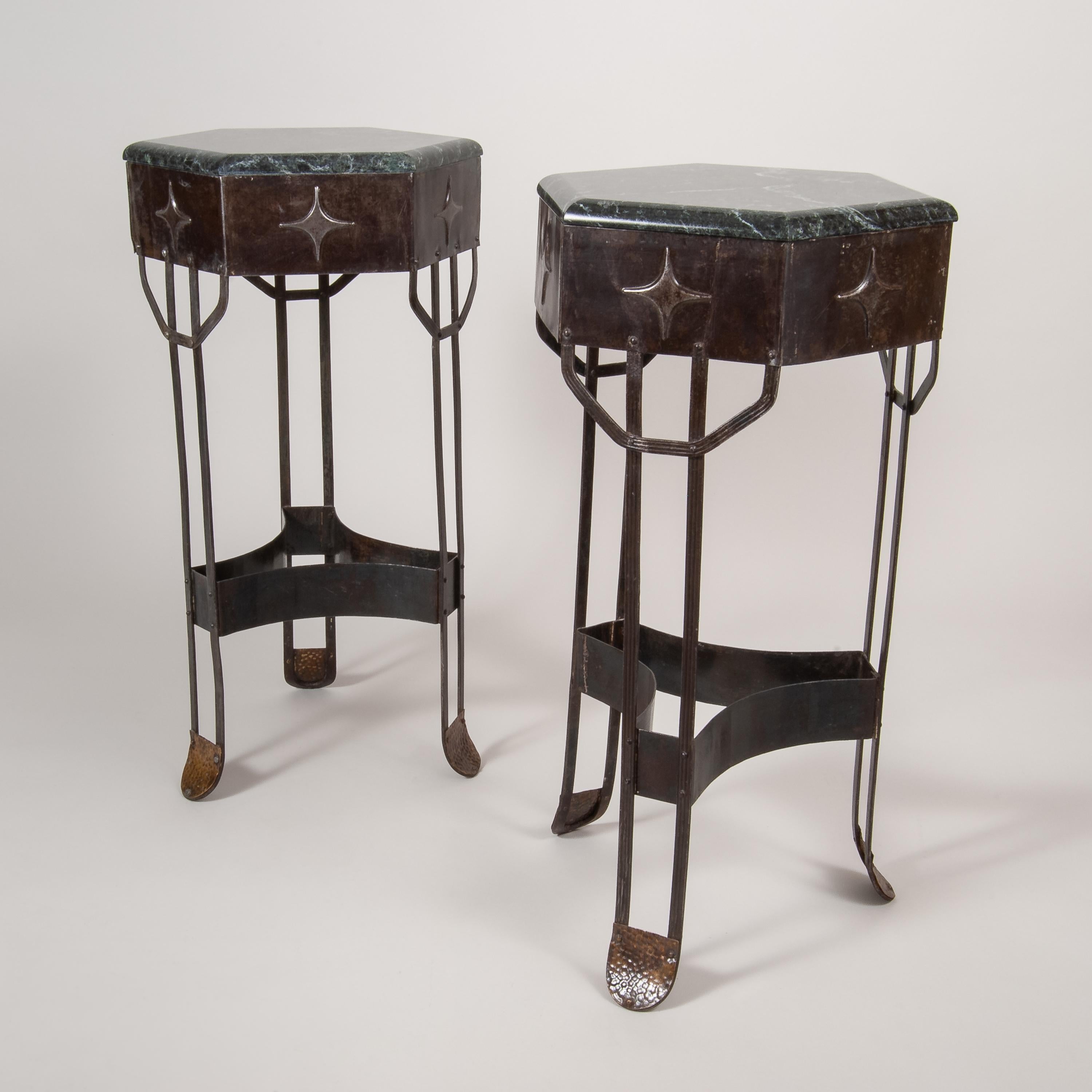 Beautiful and rare pair of Art Deco three-legged pedestals in wrought iron with dark green 