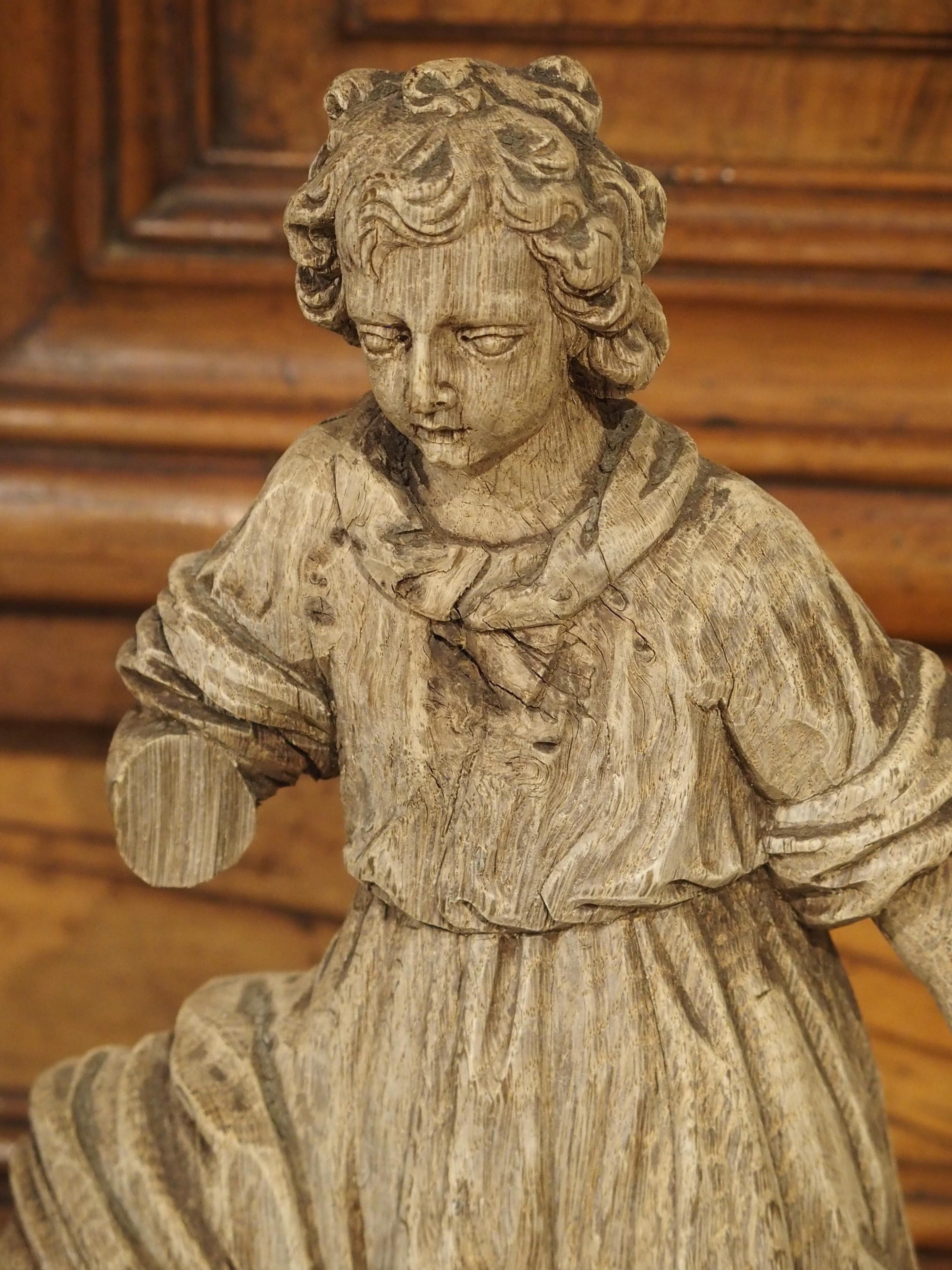 These beautiful French Baroque angels are over 350 years old, having been hand-carved in oak circa 1670. Oak was the predominate wood used for making furniture up through the 1700s. The beautifully grained wood is strong and sturdy, ensuring that