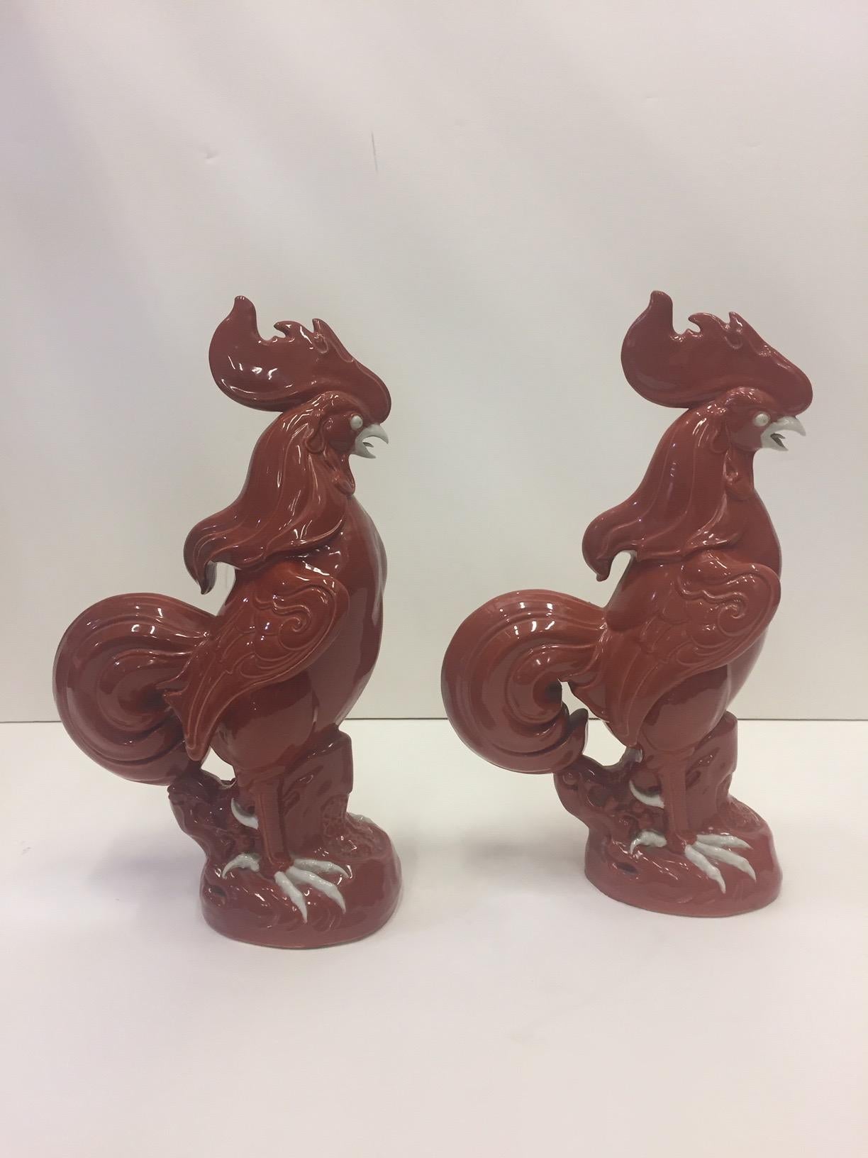 Eye-catching Chinese pair of porcelain rooster sculptures in a fabulous brick red with white accents. Great details and attitude.