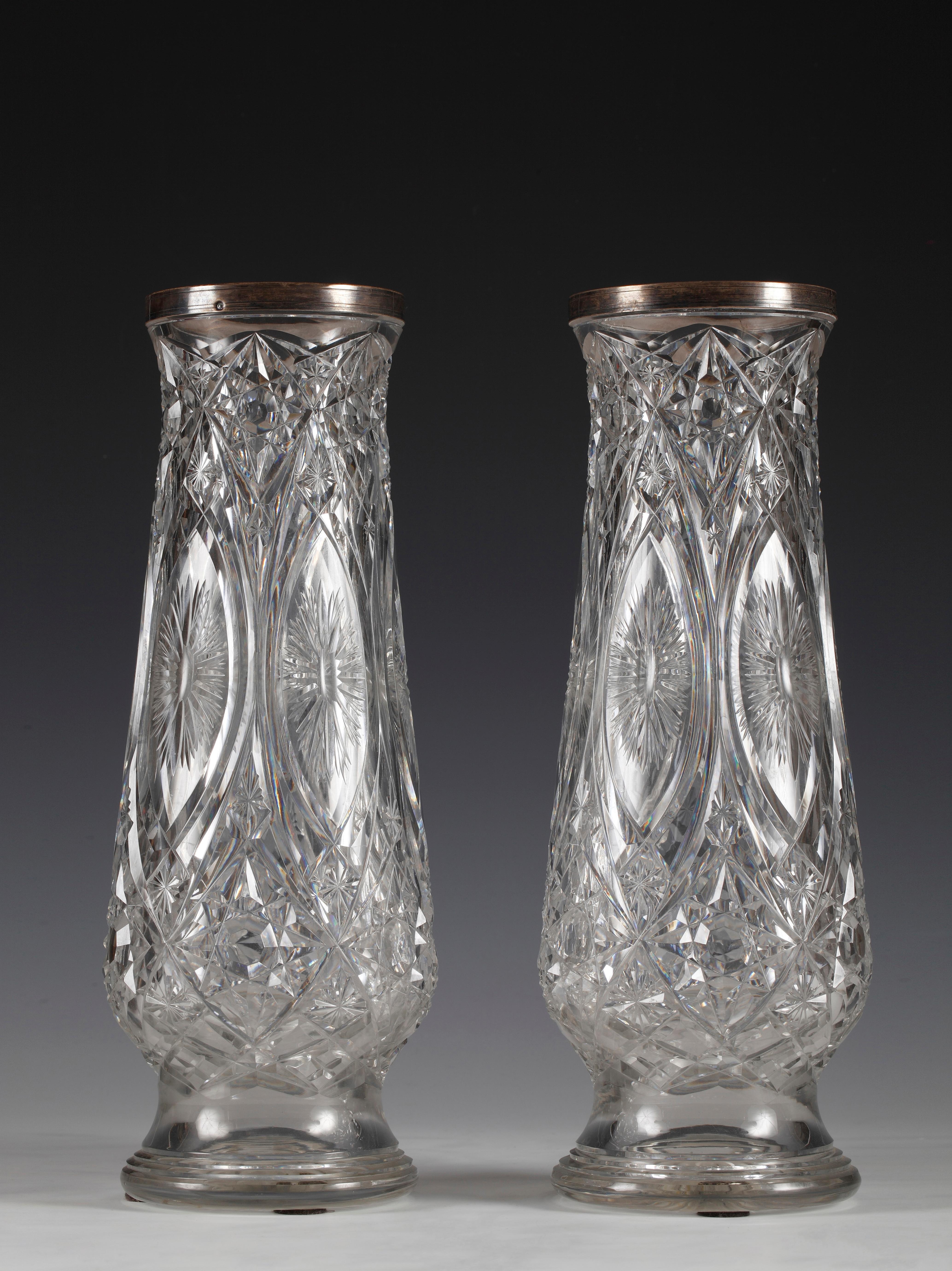 Pair of baluster shaped vases attributed to Baccarat, made in fine cut-crystal, all-over decorated with star and diamond motifs. Mounted at the mouth with a large sterling silver ring.

The famous crystal manufacture of Baccarat, that dates back