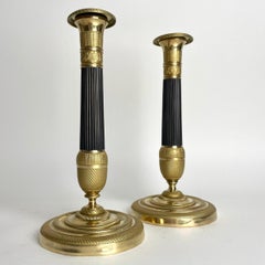 Beautiful pair of Empire Candlesticks in gilt and dark patinated bronze. 1820s