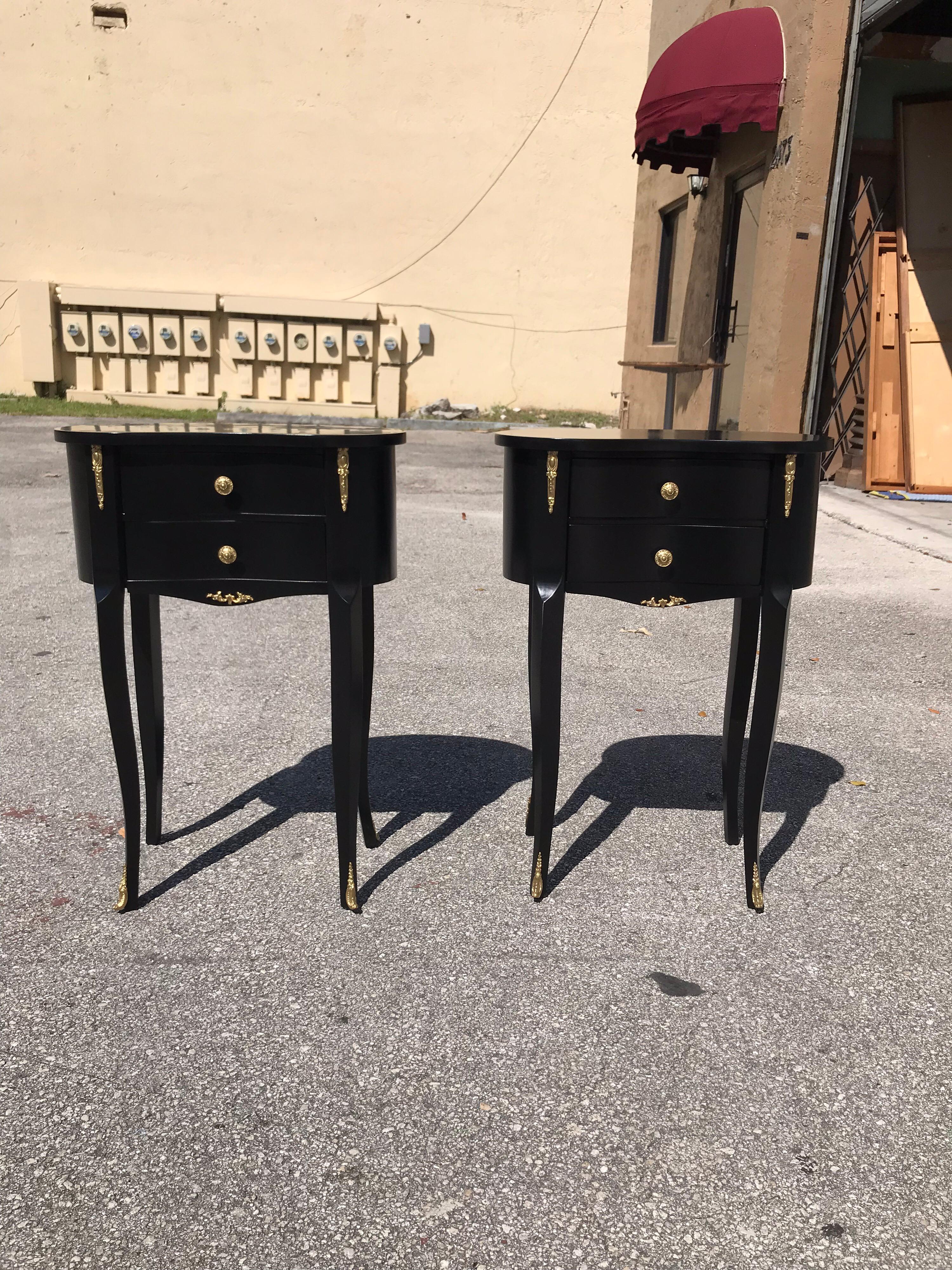 Beautiful pair of French Louis XV side tables or accent table, 1920s, made of solid mahogany that have been ebonized and finished with a French polish, each table is with brass detail and features elegant finely cast brass hardware, two drawers and