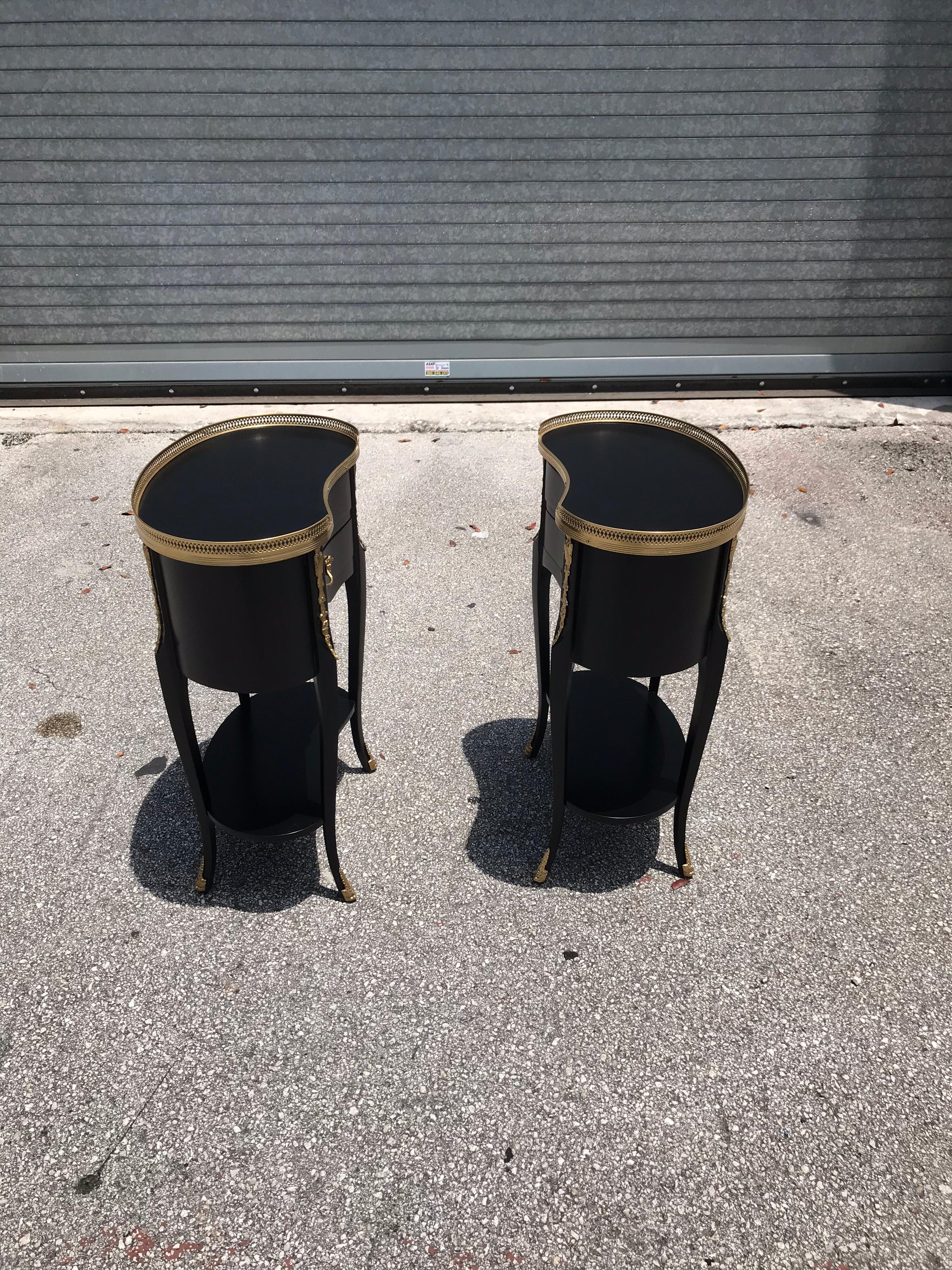 Beautiful pair of French louis xv side tables or accent table, 1920s, made of solid mahogany that have been ebonized and finished with a French polish, each table is with brass detail and features elegant finely cast brass hardware, two drawers and