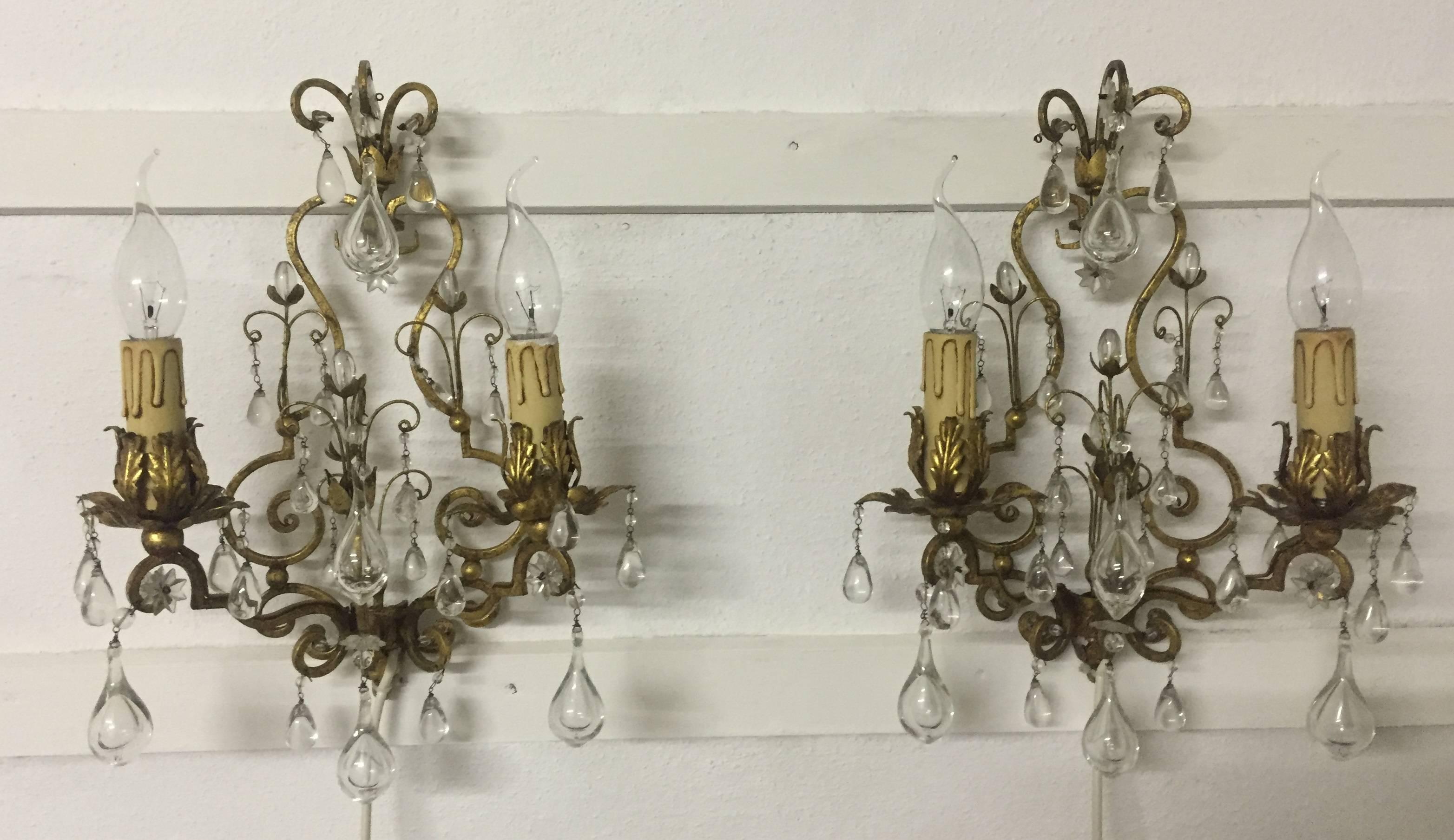 A beautiful pair of gilt iron and crystal glass wall sconces, Italy, circa 1950s.
Socket: each two x Edison (E14) for standard screw bulbs.
