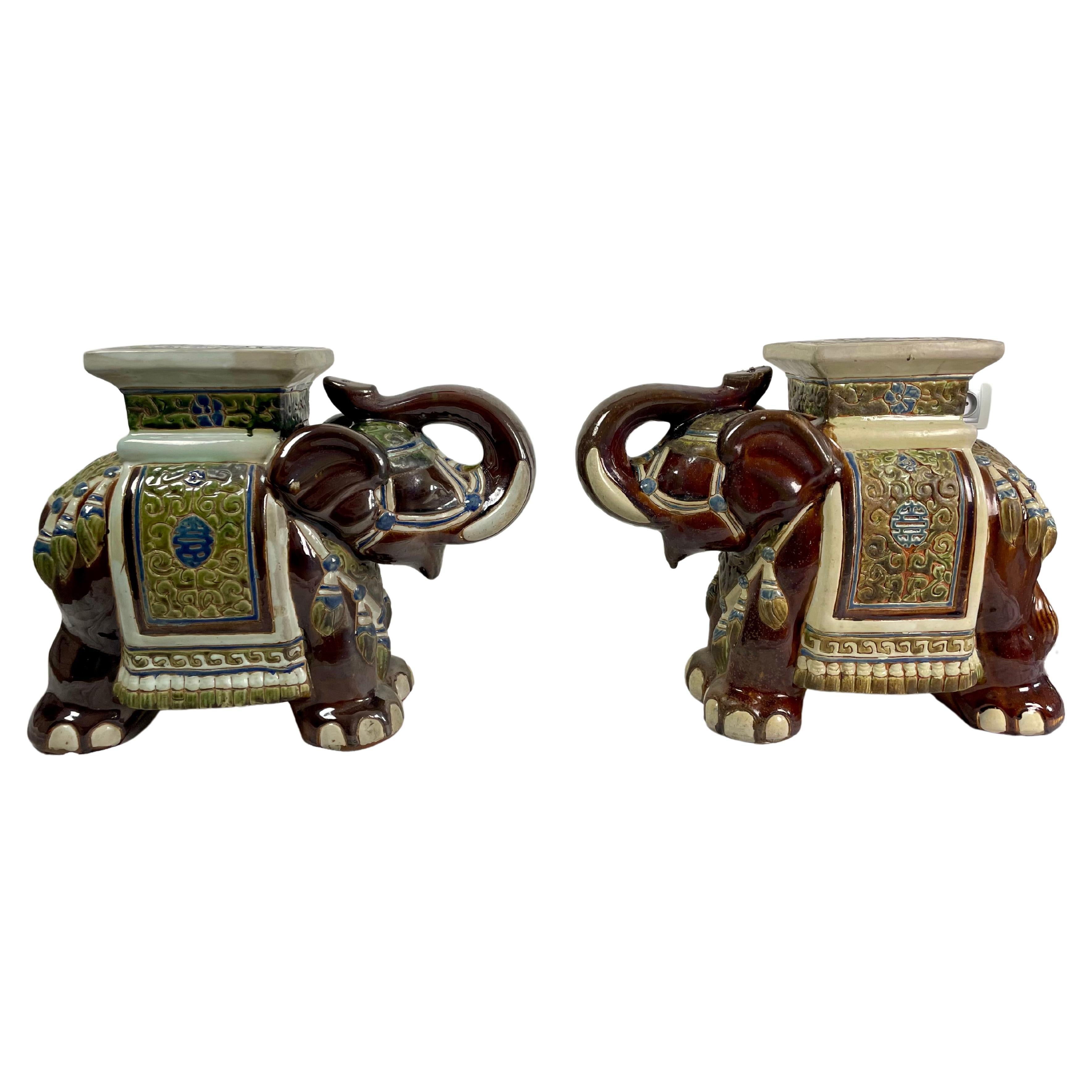 Pretty pair of very decorative garden stools or plant stands or side tables in the shape of Asian elephants.
Hand painted ceramic.
The elephants are in ceremonial dress, the costume patterns are delicate and reminiscent of Asia and the Silk