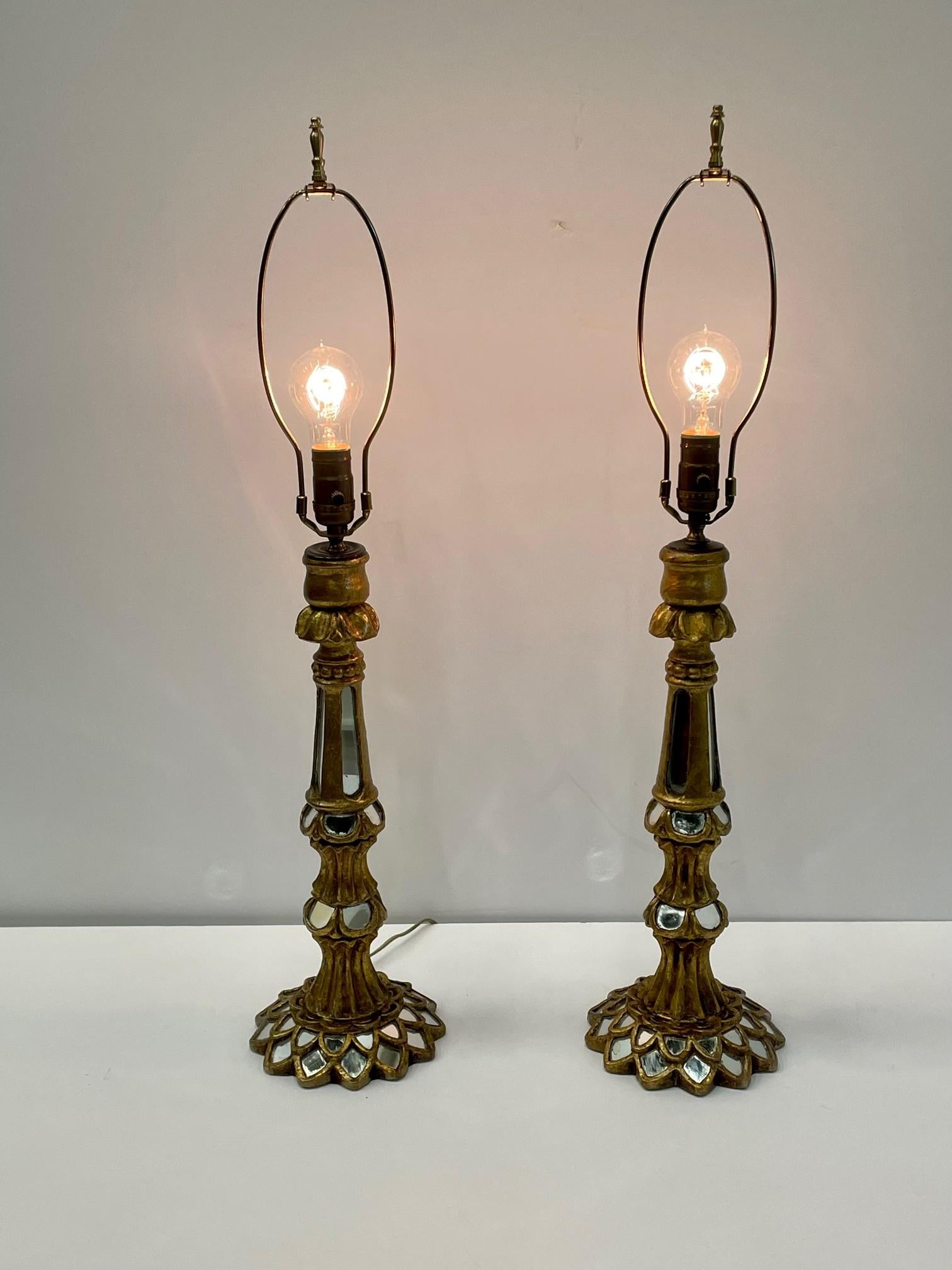 Glistening pair of lovely Italian giltwood table lamps having inset pieces of mirror that add glamour and shine. Shades not included.