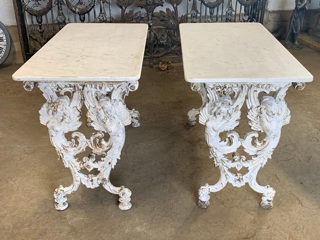 A stunning and rare pair of Italian bistro tables with winged Angels. The bases are cast iron with original marble tops. These would make beautiful garden tables as well as indoor tables. They can also be pushed together to make a larger table.