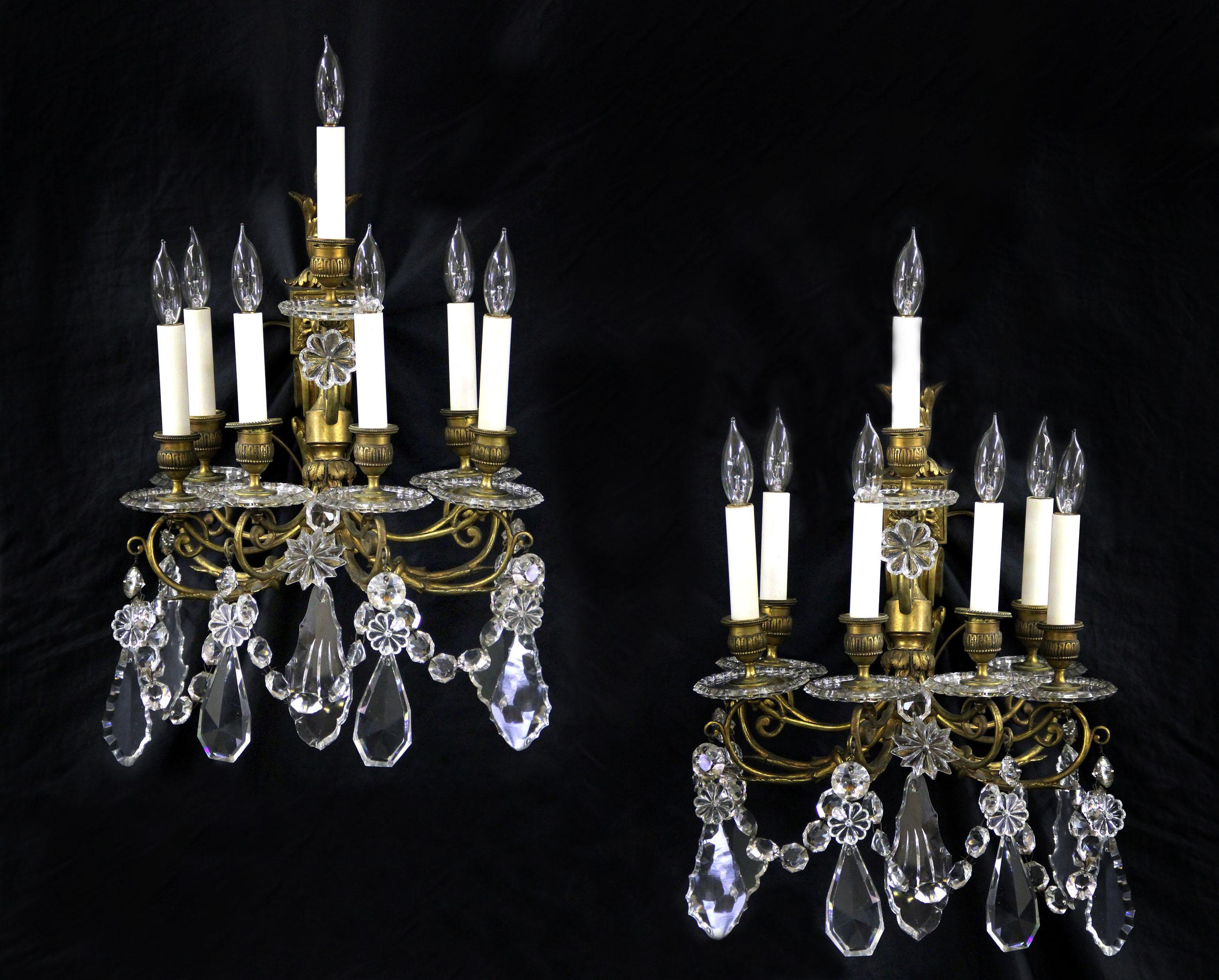A beautiful pair of late 19th century gilt bronze crystal seven light sconces

multifaceted and shaped crystal, bobeche cups.