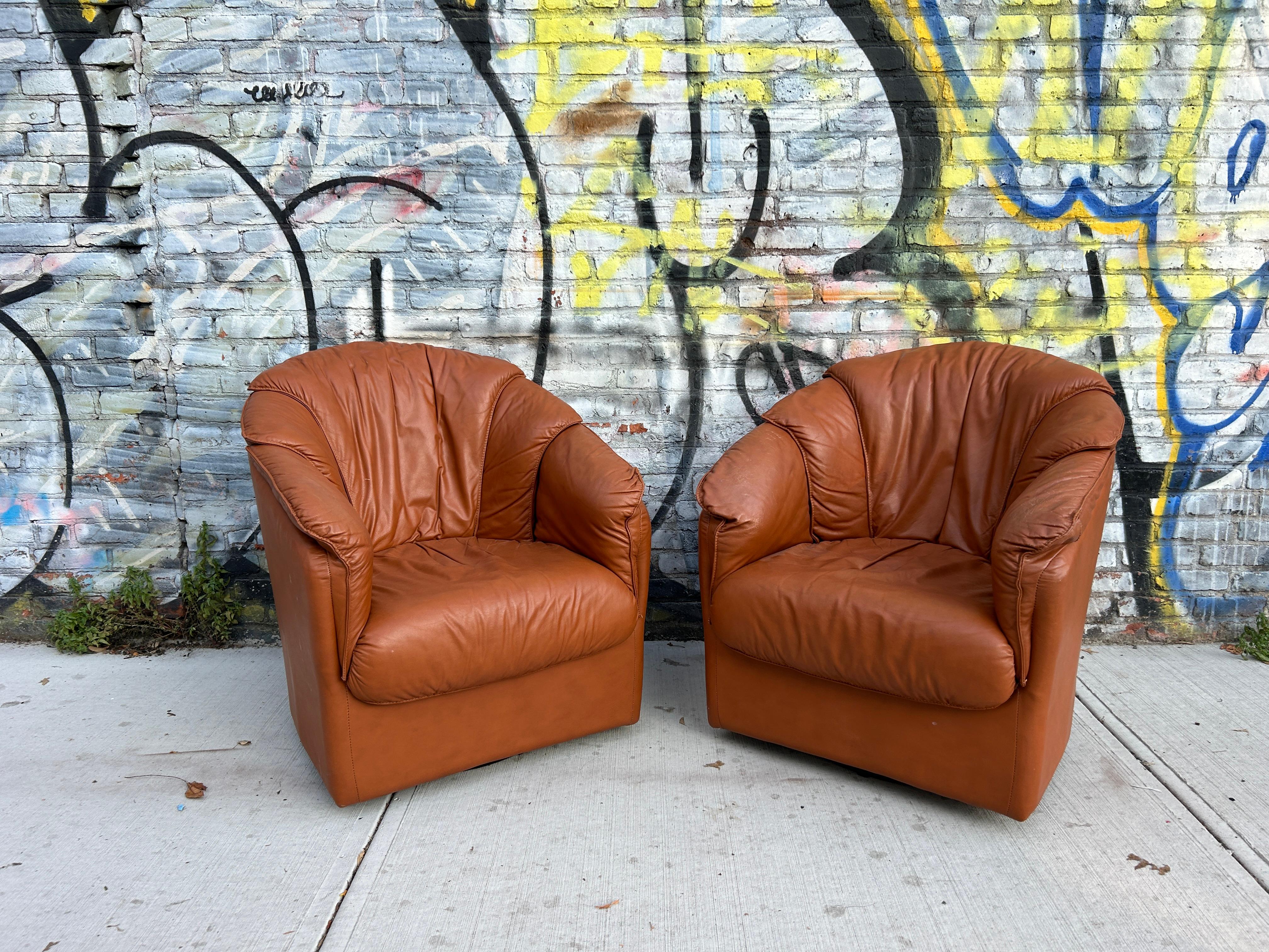 Beautiful pair of leather chairs Post modern design Natuzzi Salotti Swivel lounge Chairs are beyond stunning. Premium Italian leather. The seats are very comfortable and finely crafted. It is made using the best manufacturing processes with