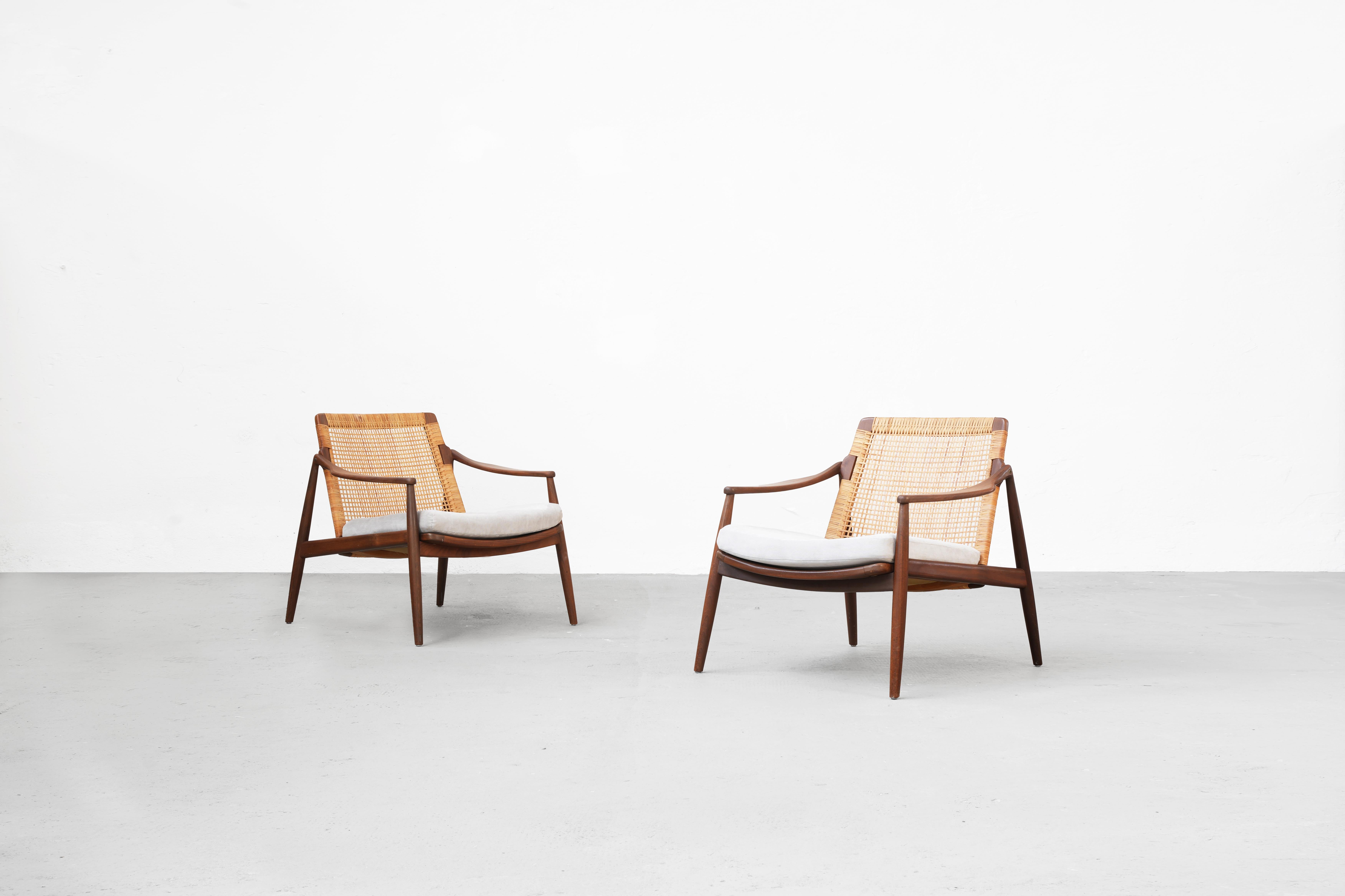 Very rare and beautiful pair of lounge chairs designed by Hartmut Lohmeyer for Wilkhahn in the 1950s, made in Germany. 
Beautifully shaped and newly reupholstered with light gray fabric. The cane mesh and the teak wood frame are in good condition.