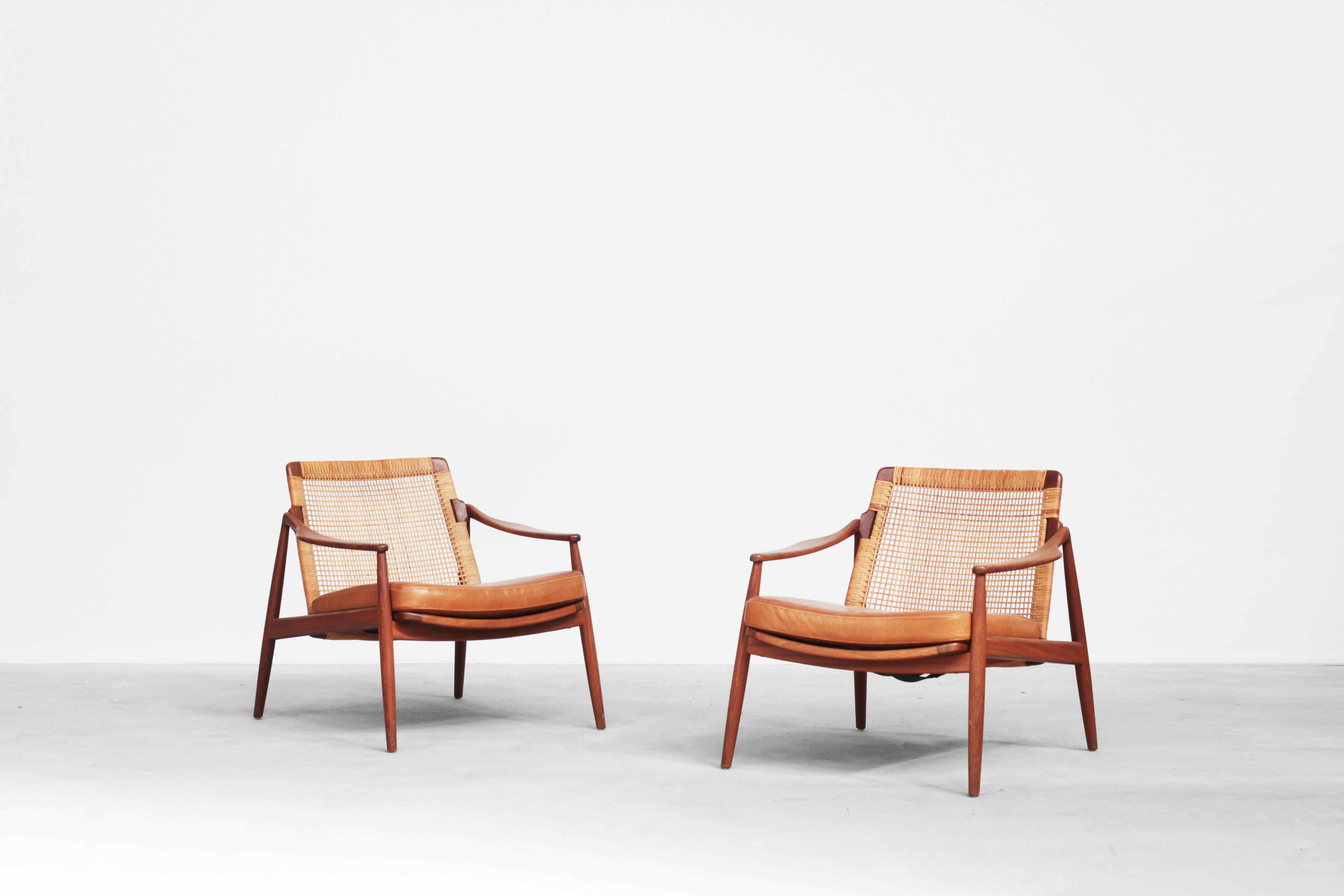 Very beautiful lounge chairs designed by Hartmut Lohmeyer for Wilkhahn in the 1950s, made in Germany. Very beautifully shaped, newly reupholstered with a high-quality leather in brown-cognac, the cane, and the teak wood frame are in excellent