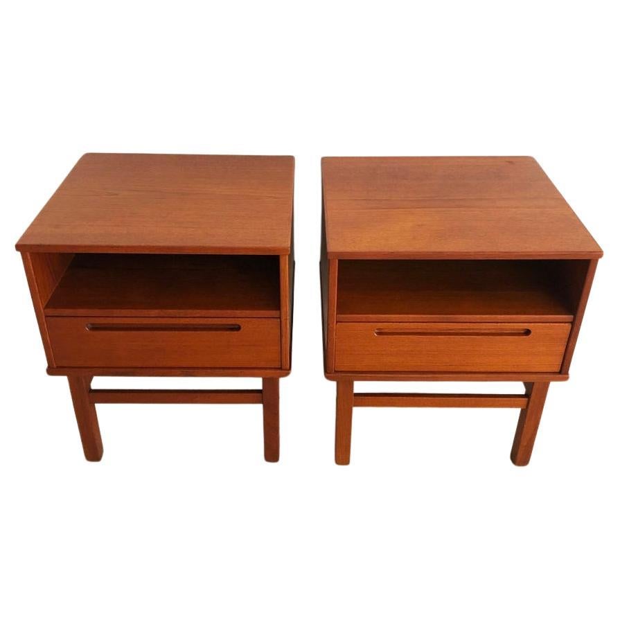 Beautiful pair of teak mid century nightstands made in Denmark. Designed by Nils Jonsson for HJN Mobler. Square body and legs. Single cubby and upper drawer with inset handle. Dovetail construction is beautiful. Good vintage condition clean inside