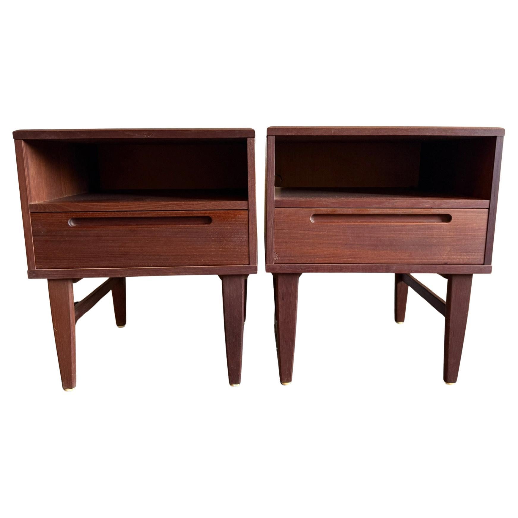 Beautiful pair of teak mid century single drawer nightstands made in Denmark. Designed by Nils Jonsson for HJN Mobler. Single cubby and lower drawer with inset handle. Dovetail construction is beautiful. Good vintage condition clean inside and out