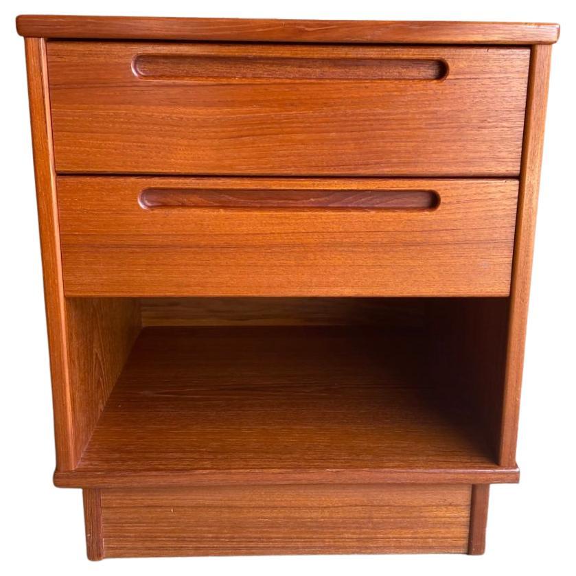 Beautiful pair of teak mid century 2 drawer nightstands made in Denmark. Designed by Peter Arenkiel Jensen for Tørring Møbelfabrik. Square body and platform base. Single lower cubby and (2) upper drawers with inset handle. Dovetail construction is