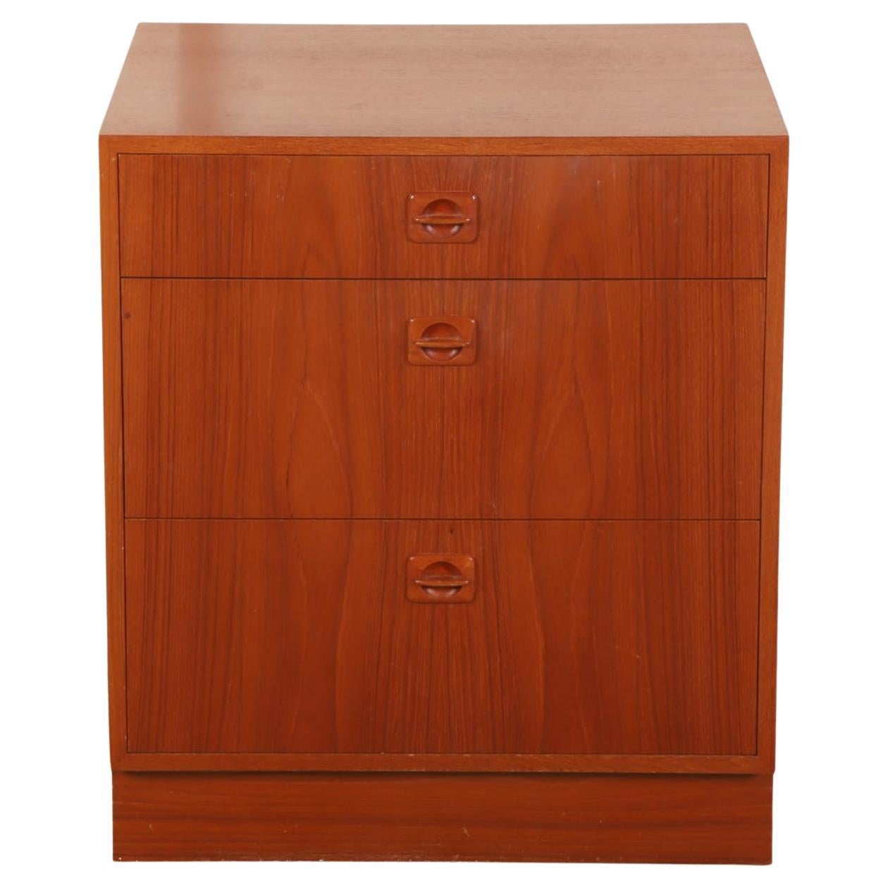 Beautiful pair of teak mid century 3 drawer nightstands made in Denmark. Square body and platform base. Each nightstand has (3) drawers with inset carved handles. Teak grain is beautiful. Good vintage condition clean inside and out. Located in