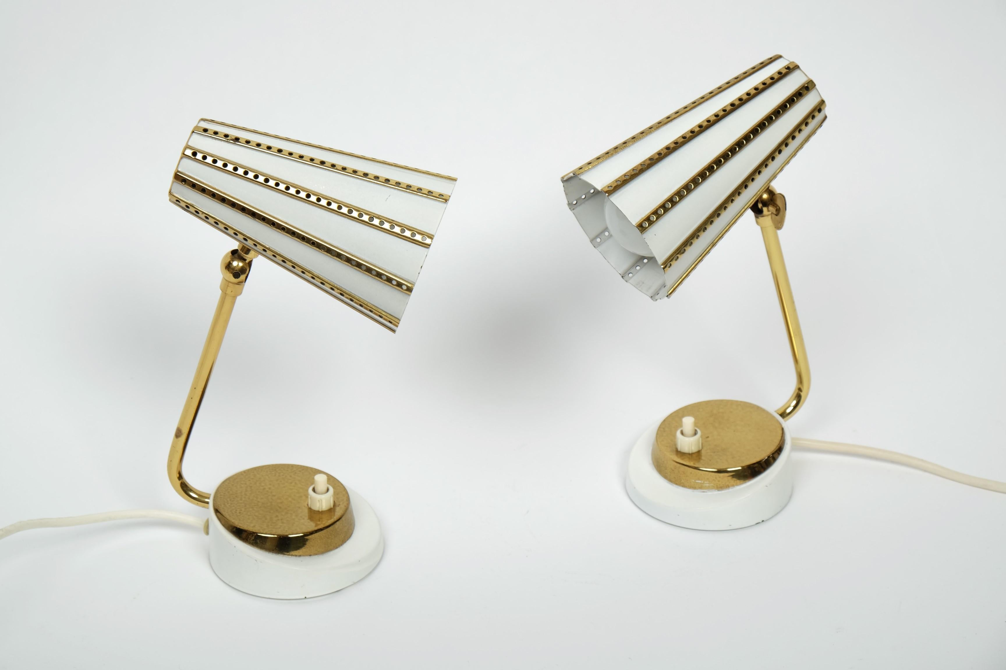 Beautiful pair of mid-century brass table or bedside lamps with perforated metal shade, Germany 1950s.

Very nice design. Can be used as table or bedside lamps. The lampshades can be folded up and down smoothly.

The lamps are made of brass and are