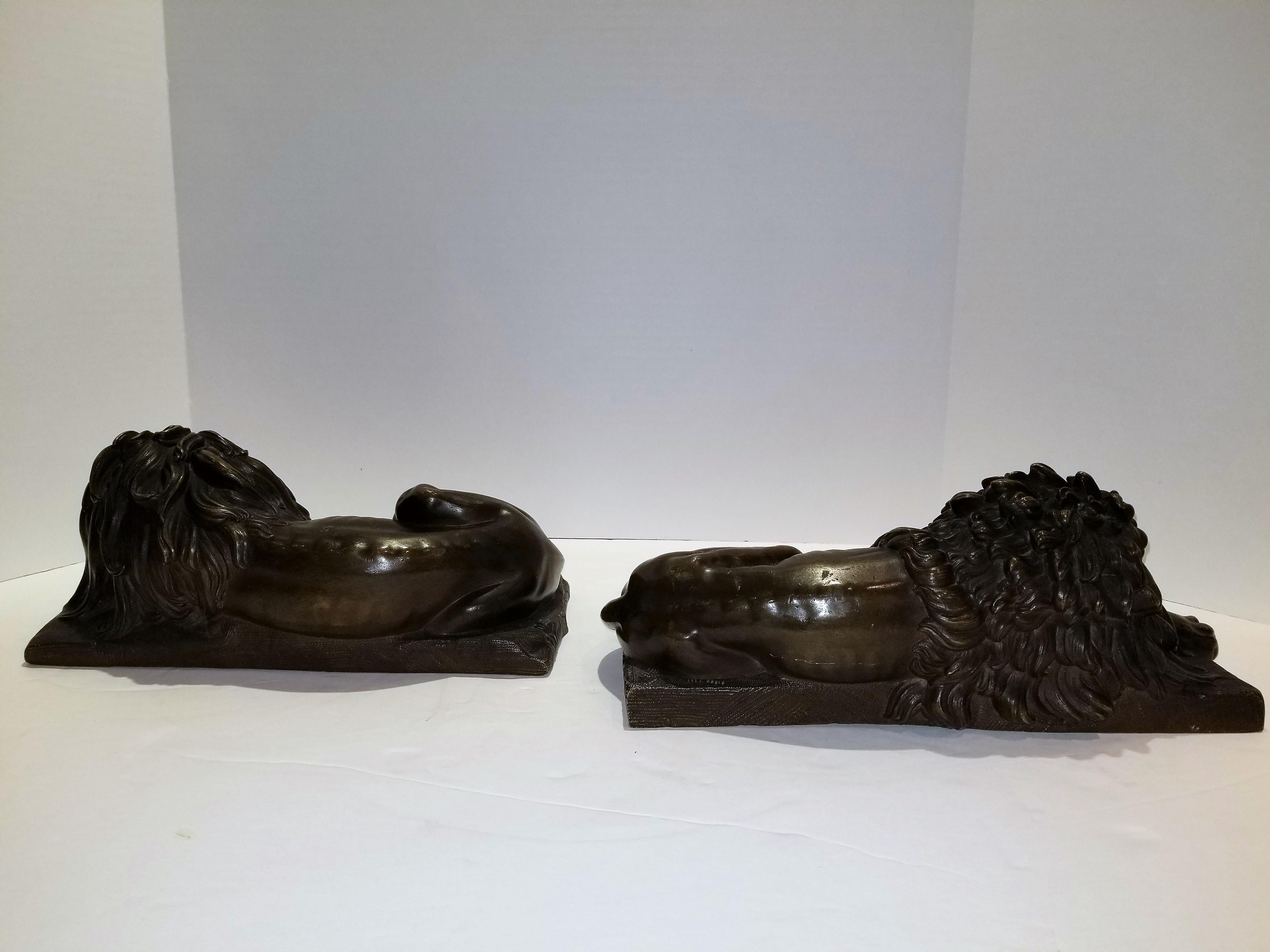 French Beautiful Pair of Patinated Resting Lions, Signed by Bernoux and Huzel For Sale