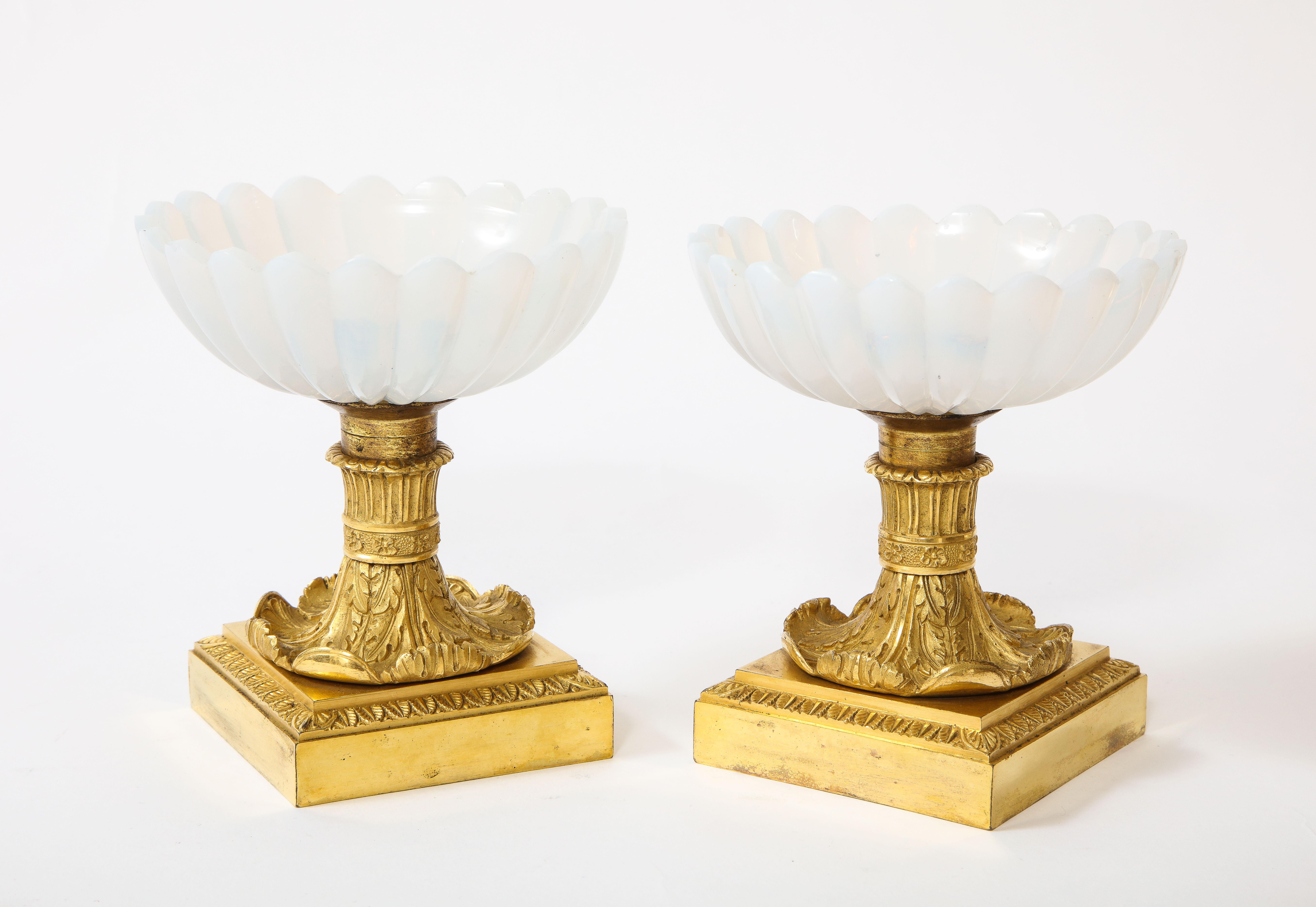 A beautiful pair of Russian Empire Imperial Glass Manufactury and ormolu mounted white opalescent tazza centrepieces, each white opaline bowl beautifully hand cut and hand polished in flutted design with ribbed border; the Ormolu very finely hand