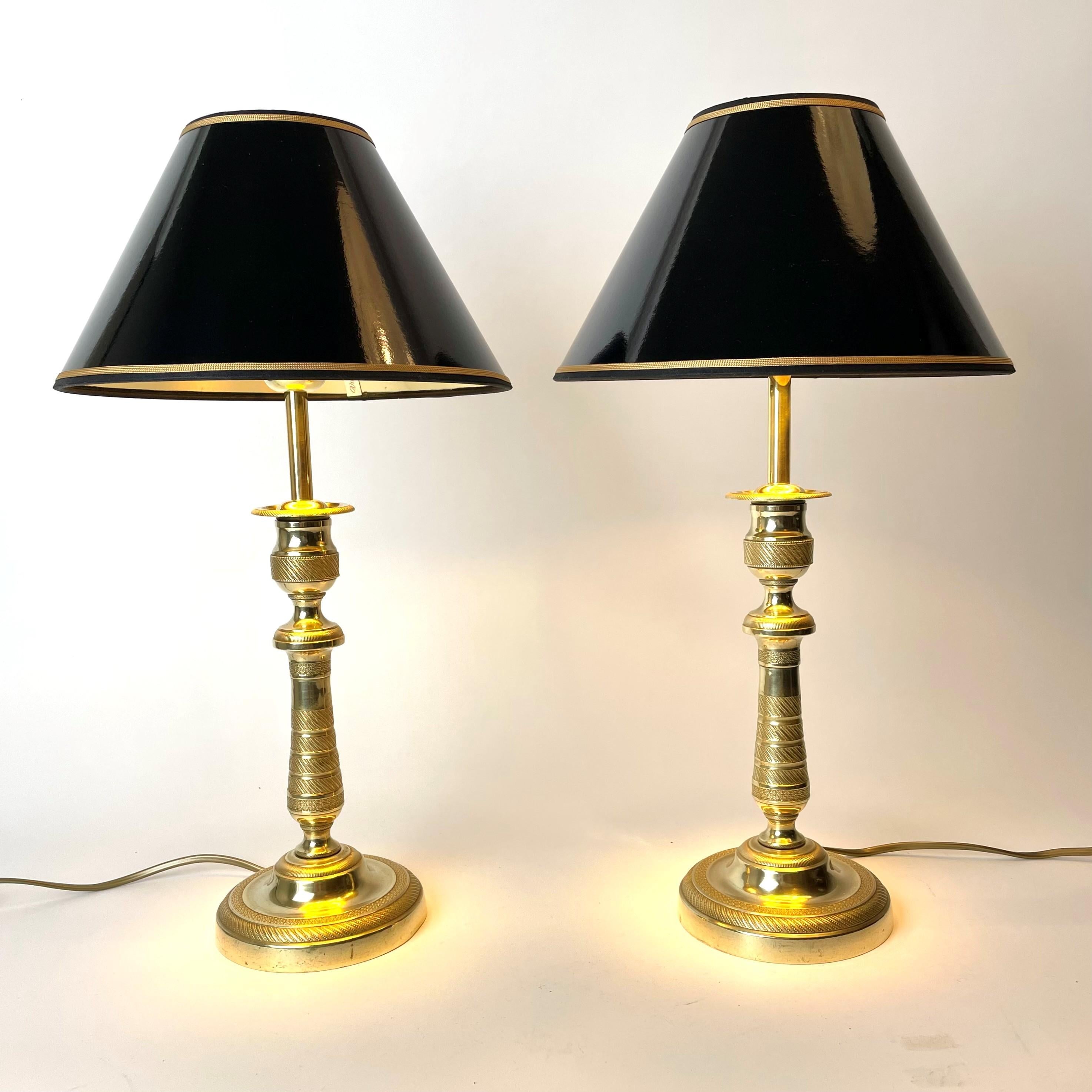 A pair of beautiful table lamp, originally Empire candlesticks in bronze that have been converted into electric table lamps. New lampshades in black lacquer with gilding on the inside to give a cozy impression.

Empire, France during 1820s,