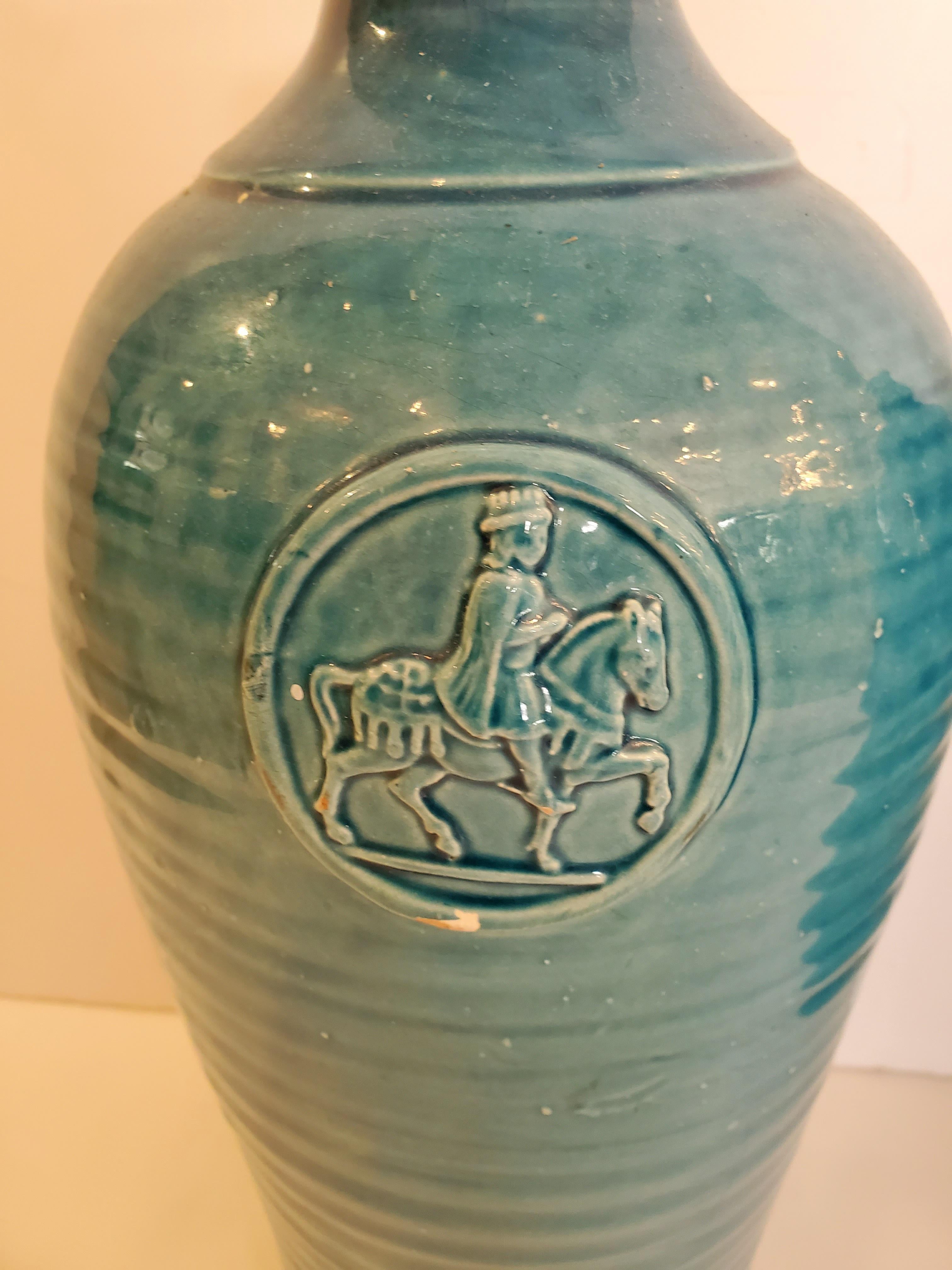 Striking Italian turquoise ceramic vases having relief decorative medallions depicting a knight on horseback.