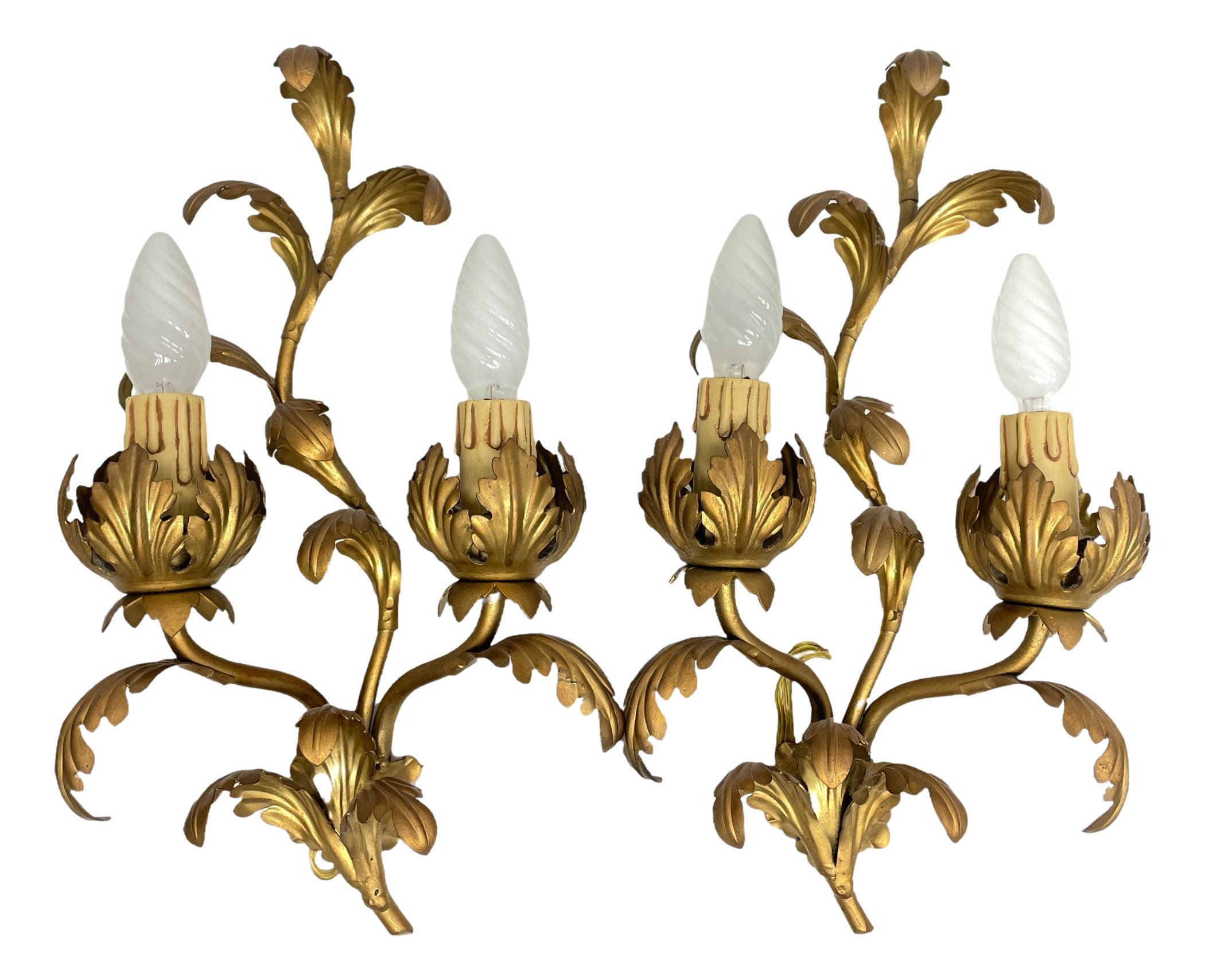 A beautiful pair Hollywood Regency midcentury gilt tole leaf sconces, each fixture requires two European E14 candelabra bulbs, each bulb up to 40 watts. The wall lights have a beautiful patina and give each room an eclectic statement. Lightbulbs
