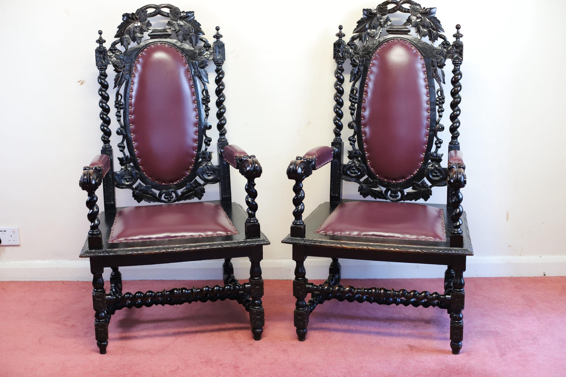 We delight to offer for sale this amazing pair of Victorian Carolean design open armchairs, the cresting rail pierced and carved with foliage over trailing grape vine and spiral turned supports, oval back, seat and arms upholstered in purple leather